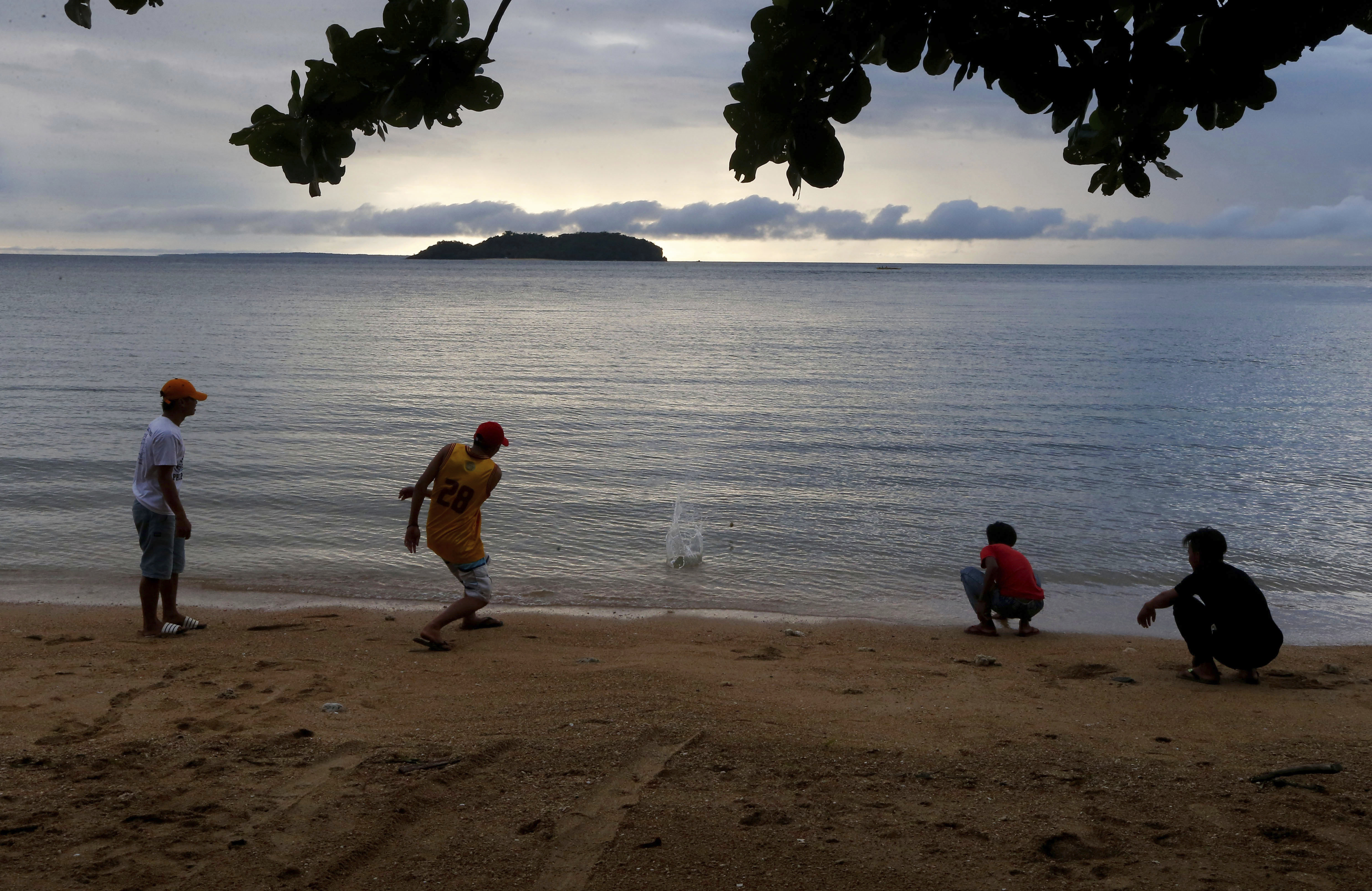 In this Jan. 27, 2019 photo, four boys play by the shore at a beach resort in Talustusan on Biliran Island in the central Philippines. Since December 2018, the small village has been rocked by controversy after about 20 boys and men, including these four, accused their Catholic parish priest Father Pius Hendricks of years of alleged sexual abuse. Bullit Marquez | AP In this Jan. 27, 2019 photo, four boys play by the shore at a beach resort in Talustusan on Biliran Island in the central Philippines. Since December 2018, the small village has been rocked by controversy after about 20 boys and men, including these four, accused their Catholic parish priest Father Pius Hendricks of years of alleged sexual abuse. Bullit Marquez | AP