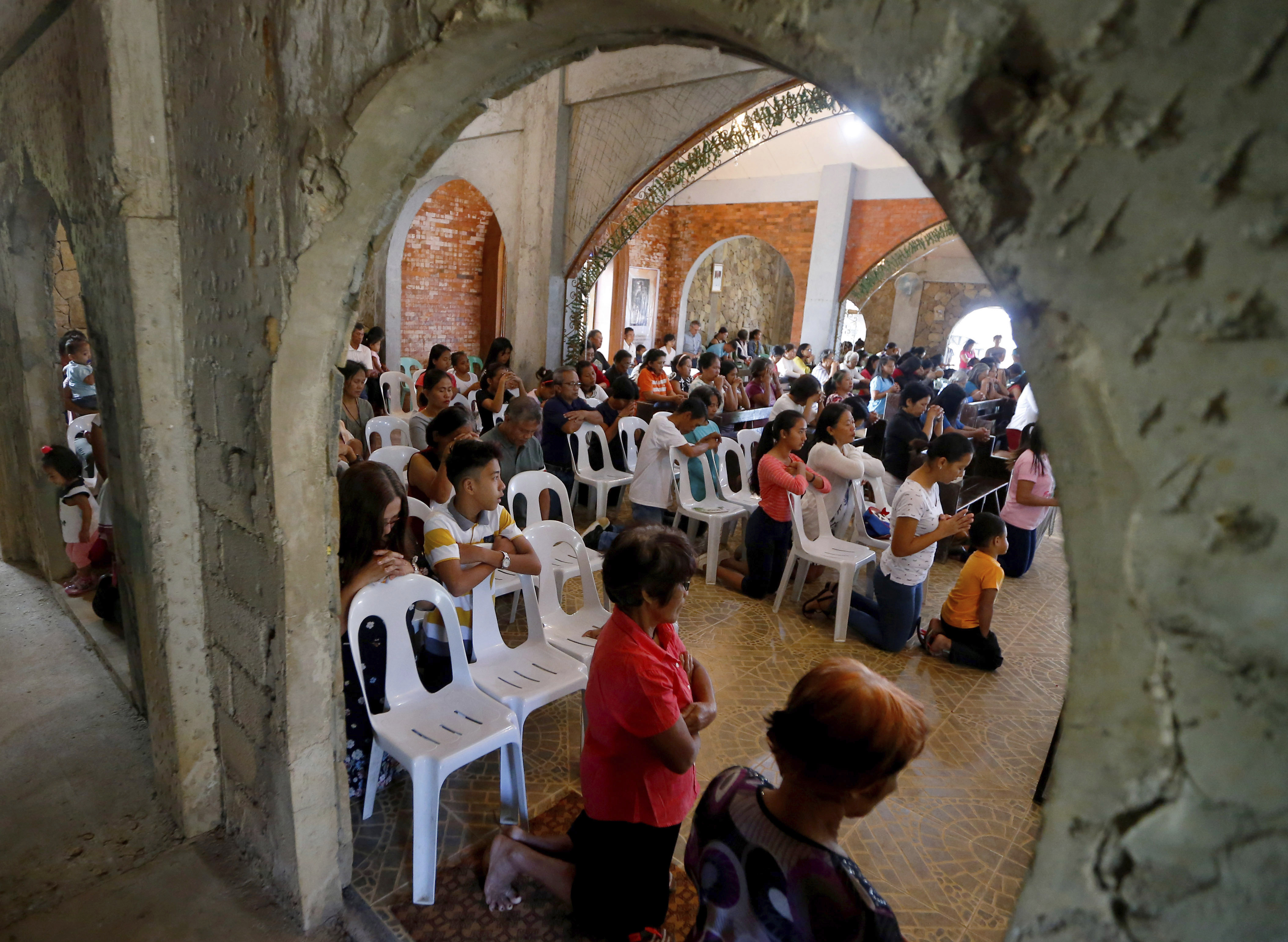 In this Jan. 27, 2019 photo, worshippers attend a Sunday Mass officiated by a substitute priest in the chapel built by U.S. priest Father Pius Hendricks in the village of Talustusan on Biliran Island in the central Philippines. Parishioners said Hendricks would ask children to occupy benches in front of the altar while saying Mass. Bullit Marquez | AP In this Jan. 27, 2019 photo, worshippers attend a Sunday Mass officiated by a substitute priest in the chapel built by U.S. priest Father Pius Hendricks in the village of Talustusan on Biliran Island in the central Philippines. Parishioners said Hendricks would ask children to occupy benches in front of the altar while saying Mass. Bullit Marquez | AP