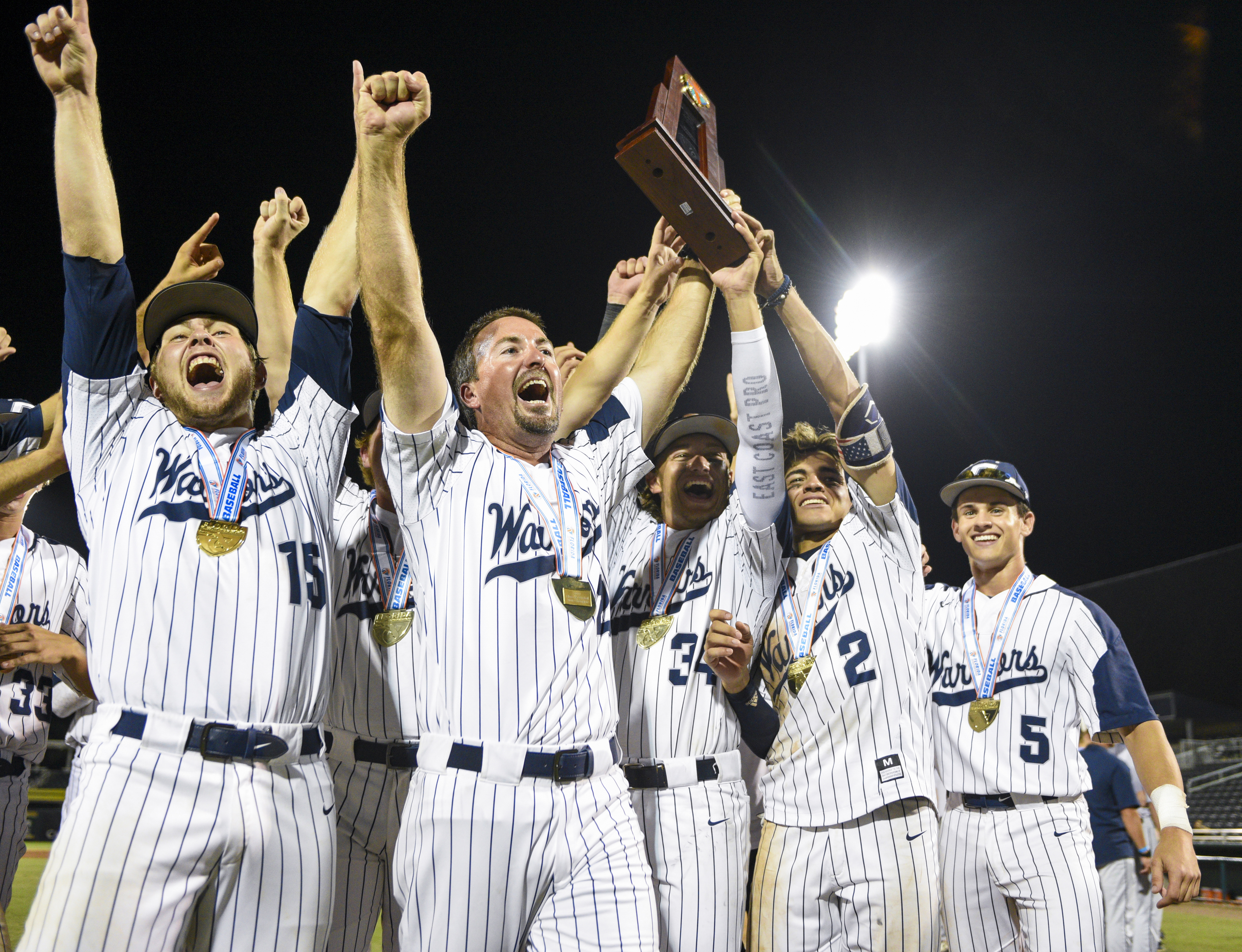 Calvary Christian coach Greg Olsen has help holding state championship trophy, the Warriors second in three years. (ALLIE GOULDING | Times) Calvary Christian coach Greg Olsen has help holding state championship trophy, the Warriors second in three years. (ALLIE GOULDING | Times)