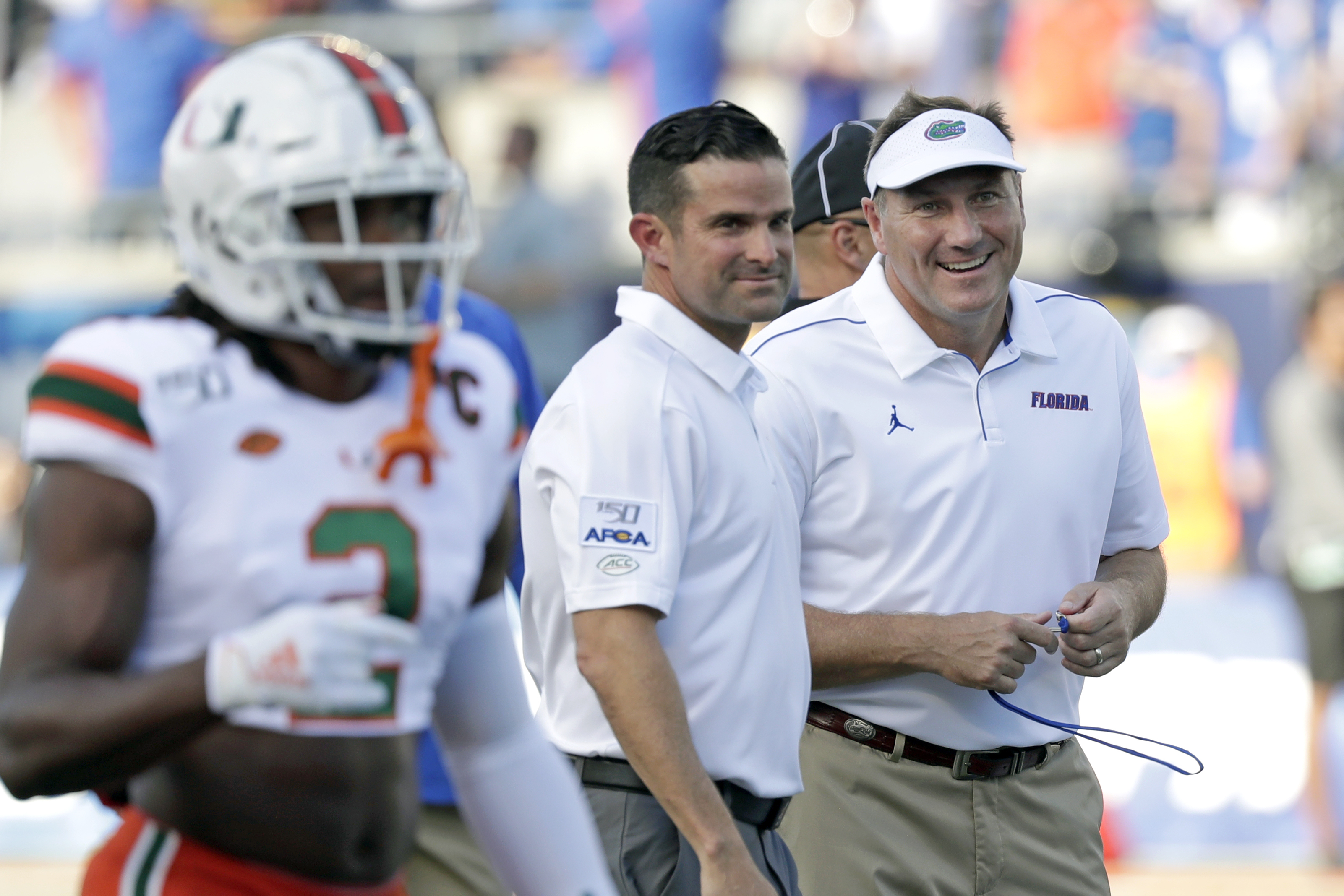 Miami head coach Manny Diaz, left, talks with Florida head coach Dan Mullen before the game. John Raoux | AP Miami head coach Manny Diaz, left, talks with Florida head coach Dan Mullen before the game. John Raoux | AP