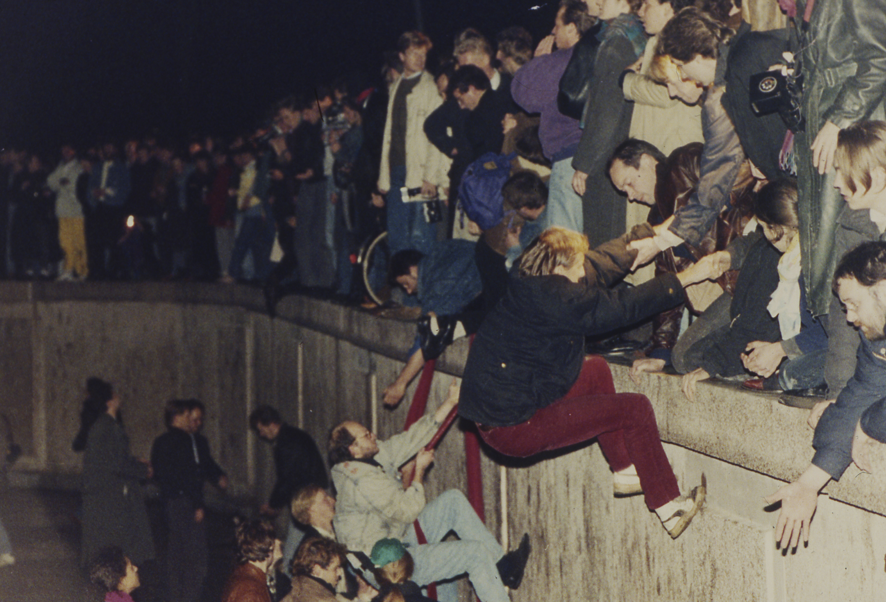 FILE - In this Nov. 10, 1989 photo, East Berliners get helping hands from West Berliners as they climb the Berlin Wall which has divided the city since the end of World War II, near the Brandenburger Tor (Brandenburg Gate). Jockel Finck | AP FILE - In this Nov. 10, 1989 photo, East Berliners get helping hands from West Berliners as they climb the Berlin Wall which has divided the city since the end of World War II, near the Brandenburger Tor (Brandenburg Gate). Jockel Finck | AP