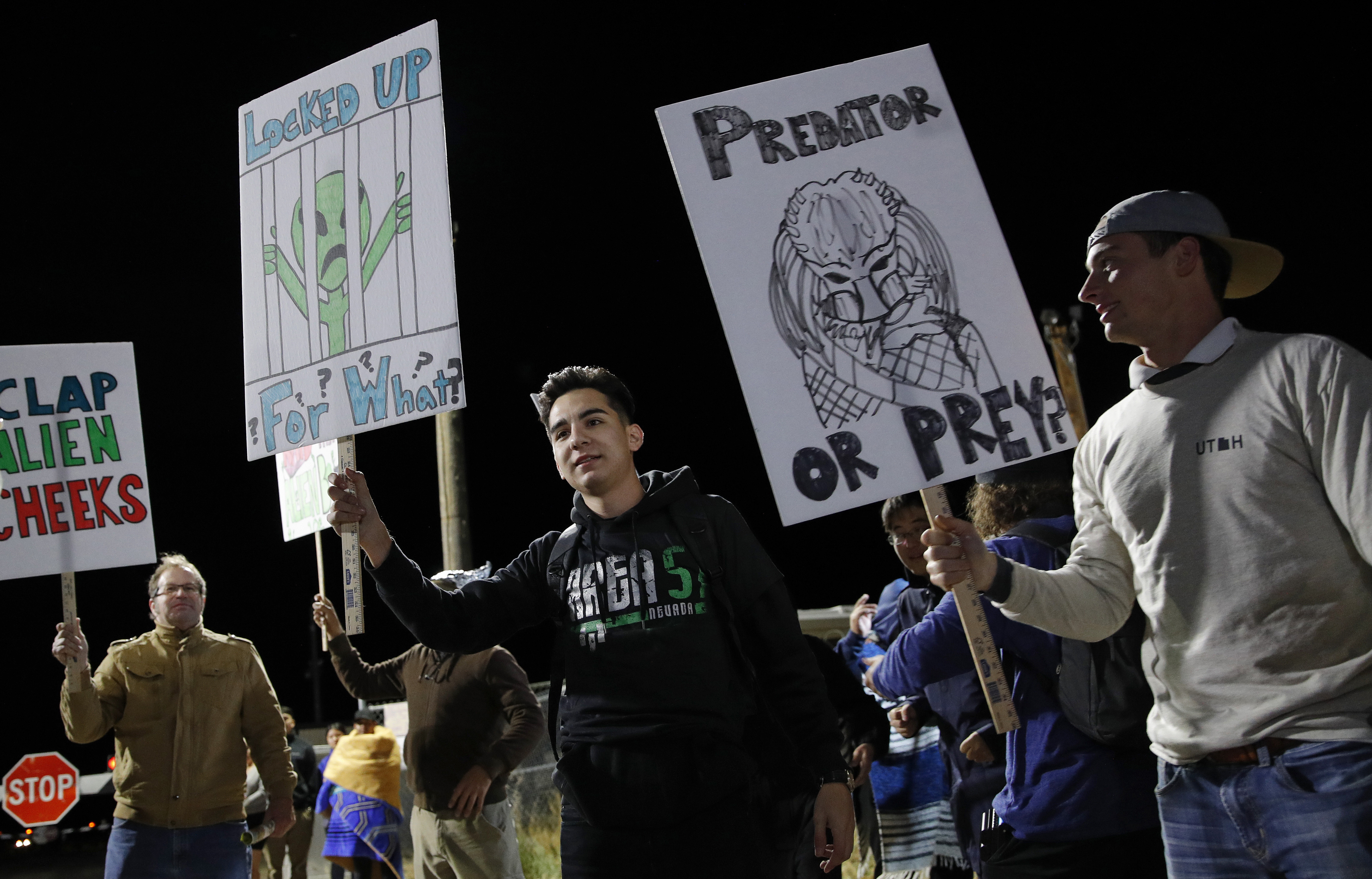 People holds signs at an entrance to the Nevada Test and Training Range near Area 51 Friday, Sept. 20, 2019, near Rachel, Nev. People gathered at the gate inspired by the People holds signs at an entrance to the Nevada Test and Training Range near Area 51 Friday, Sept. 20, 2019, near Rachel, Nev. People gathered at the gate inspired by the