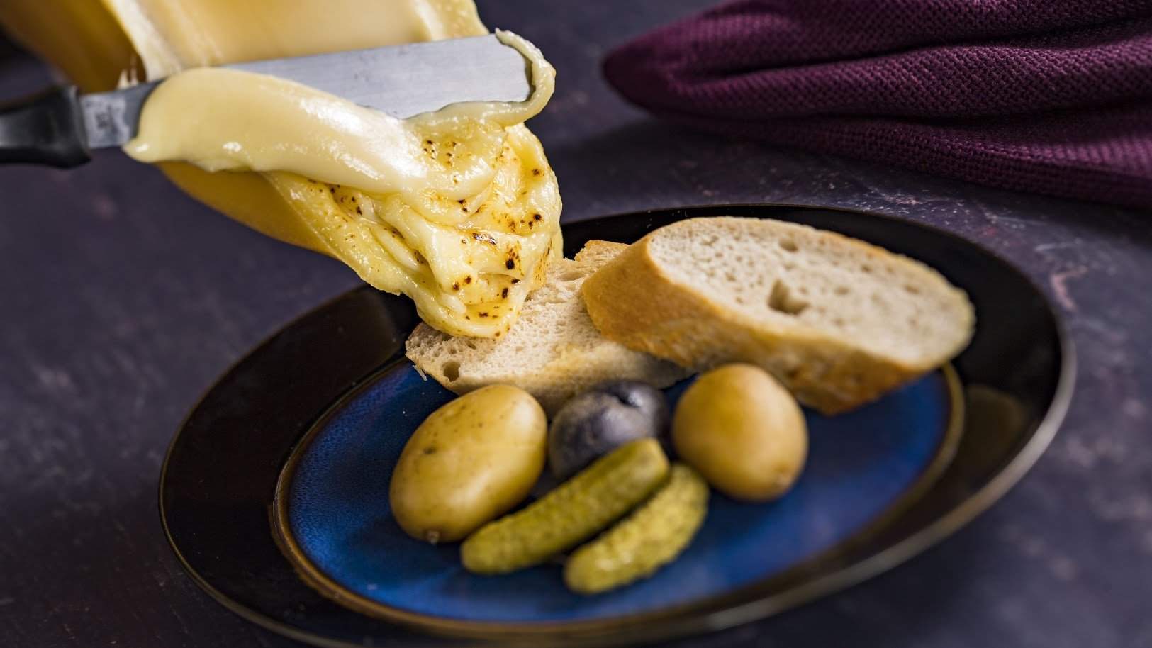 The Alps kiosk at Epcot's International Food and Wine Festival sells this gooey hunk of raclette Swiss cheese. Courtesy of Walt Disney World The Alps kiosk at Epcot's International Food and Wine Festival sells this gooey hunk of raclette Swiss cheese. Courtesy of Walt Disney World