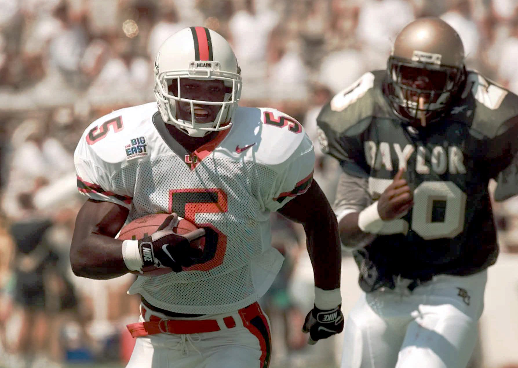 Miami running back Edgerrin James (5) runs for a 23-yard touchdown as Baylor defender Clarence Cruse (20) pursues on Aug. 30, 1997. (AP Photo/Eric Gay) Miami running back Edgerrin James (5) runs for a 23-yard touchdown as Baylor defender Clarence Cruse (20) pursues on Aug. 30, 1997. (AP Photo/Eric Gay)