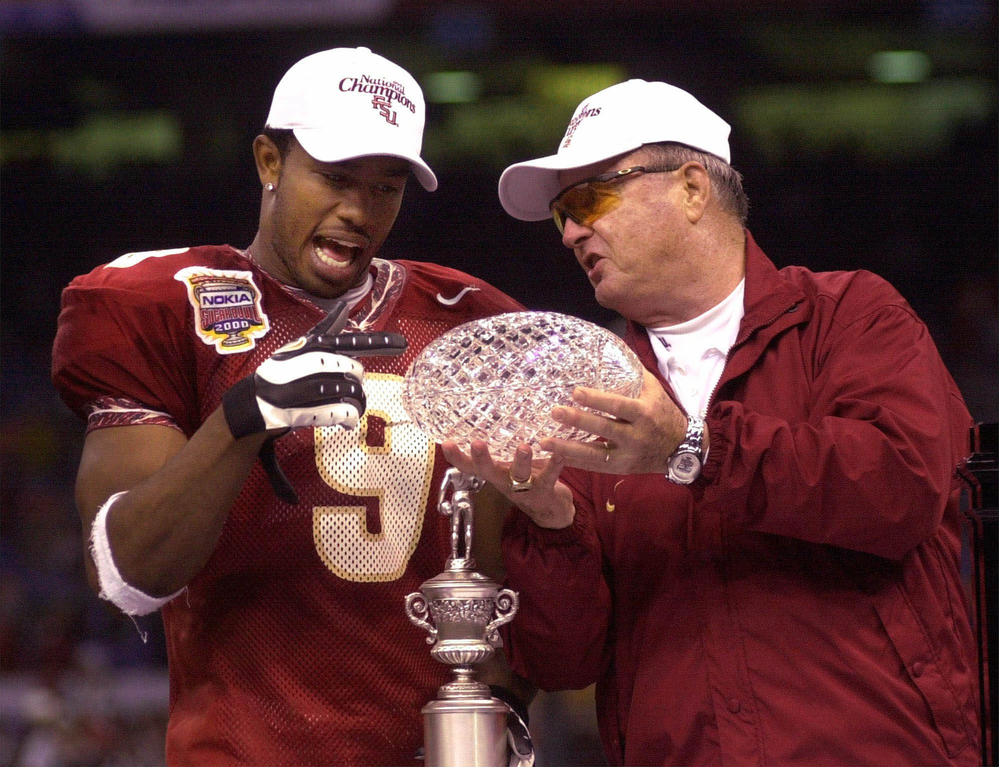 Florida State coach Bobby Bowden, right, shows the national championship trophy to the most valuable player Peter Warrick after the Seminoles beat Virginia Tech 46-29 in the Sugar Bowl, Tuesday, Jan. 4, 2000 in New Orleans. Florida State finished the season 12-0 to capture national championship. (AP Photo) Florida State coach Bobby Bowden, right, shows the national championship trophy to the most valuable player Peter Warrick after the Seminoles beat Virginia Tech 46-29 in the Sugar Bowl, Tuesday, Jan. 4, 2000 in New Orleans. Florida State finished the season 12-0 to capture national championship. (AP Photo)