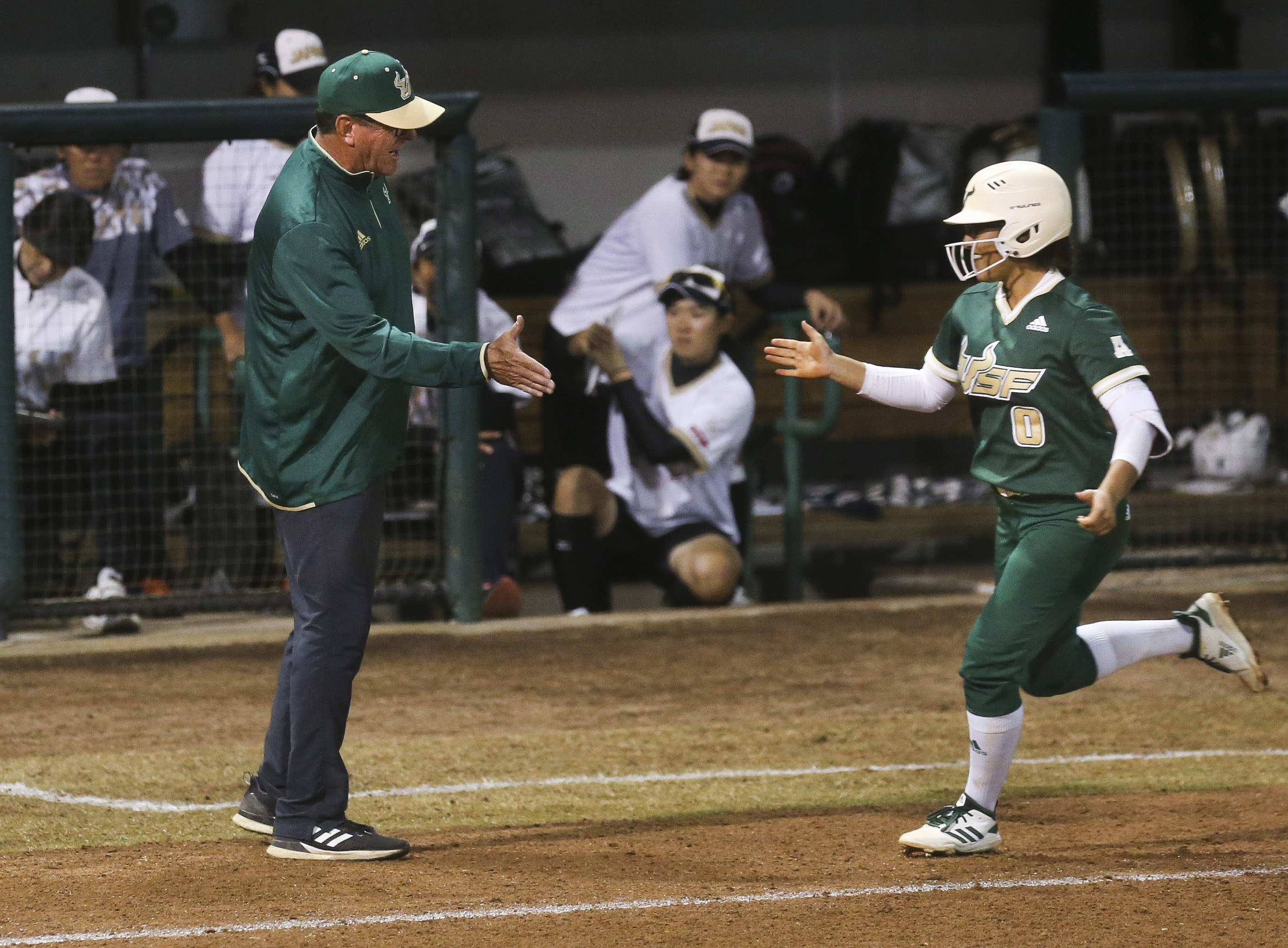 Ken Eriksen congratulates Dezarae Maldonado as she rounds third base and heads for home during an exhibition game. (DIRK SHADD | Times) Ken Eriksen congratulates Dezarae Maldonado as she rounds third base and heads for home during an exhibition game. (DIRK SHADD | Times)