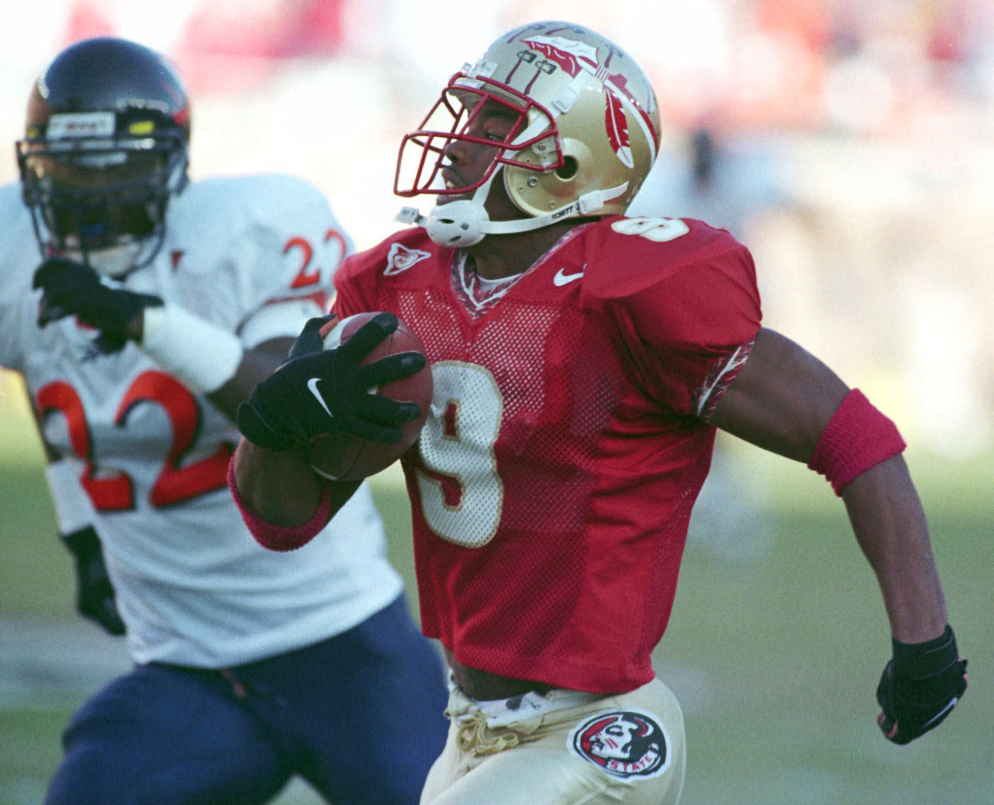 Florida State wide receiver Peter Warrick (9) pulls in a 79-yard touchdown reception as Virginia defensive back Wale Elegbe (22) chases on Nov. 7, 1998 in Tallahassee. (Associated Press/Don Edgar) Florida State wide receiver Peter Warrick (9) pulls in a 79-yard touchdown reception as Virginia defensive back Wale Elegbe (22) chases on Nov. 7, 1998 in Tallahassee. (Associated Press/Don Edgar)