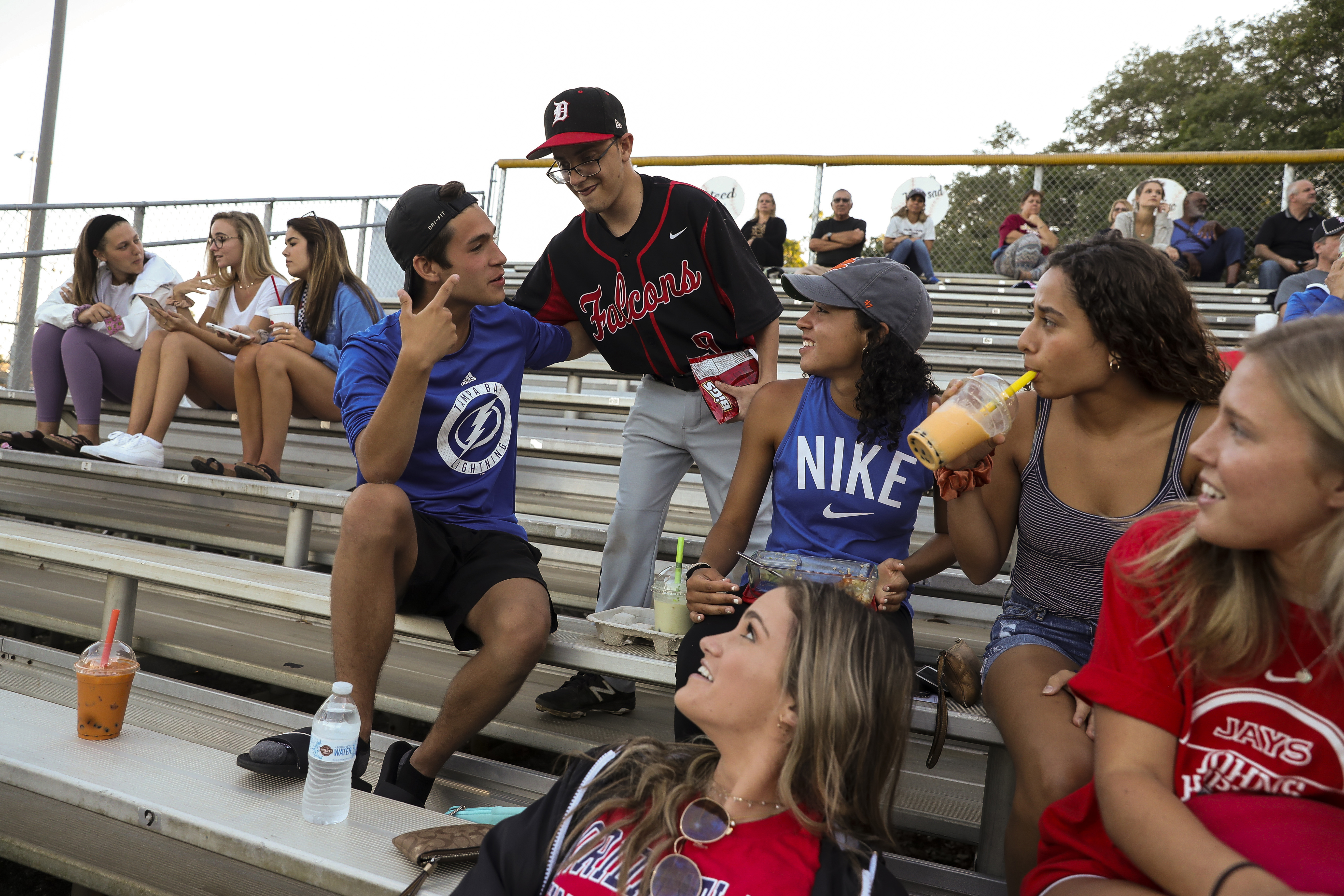 Tyler Nolan (center) greeted Joey Breese, 18, (left) in the stands, and other Dunedin High School students during the game. (MONICA HERNDON | Times) Tyler Nolan (center) greeted Joey Breese, 18, (left) in the stands, and other Dunedin High School students during the game. (MONICA HERNDON | Times)