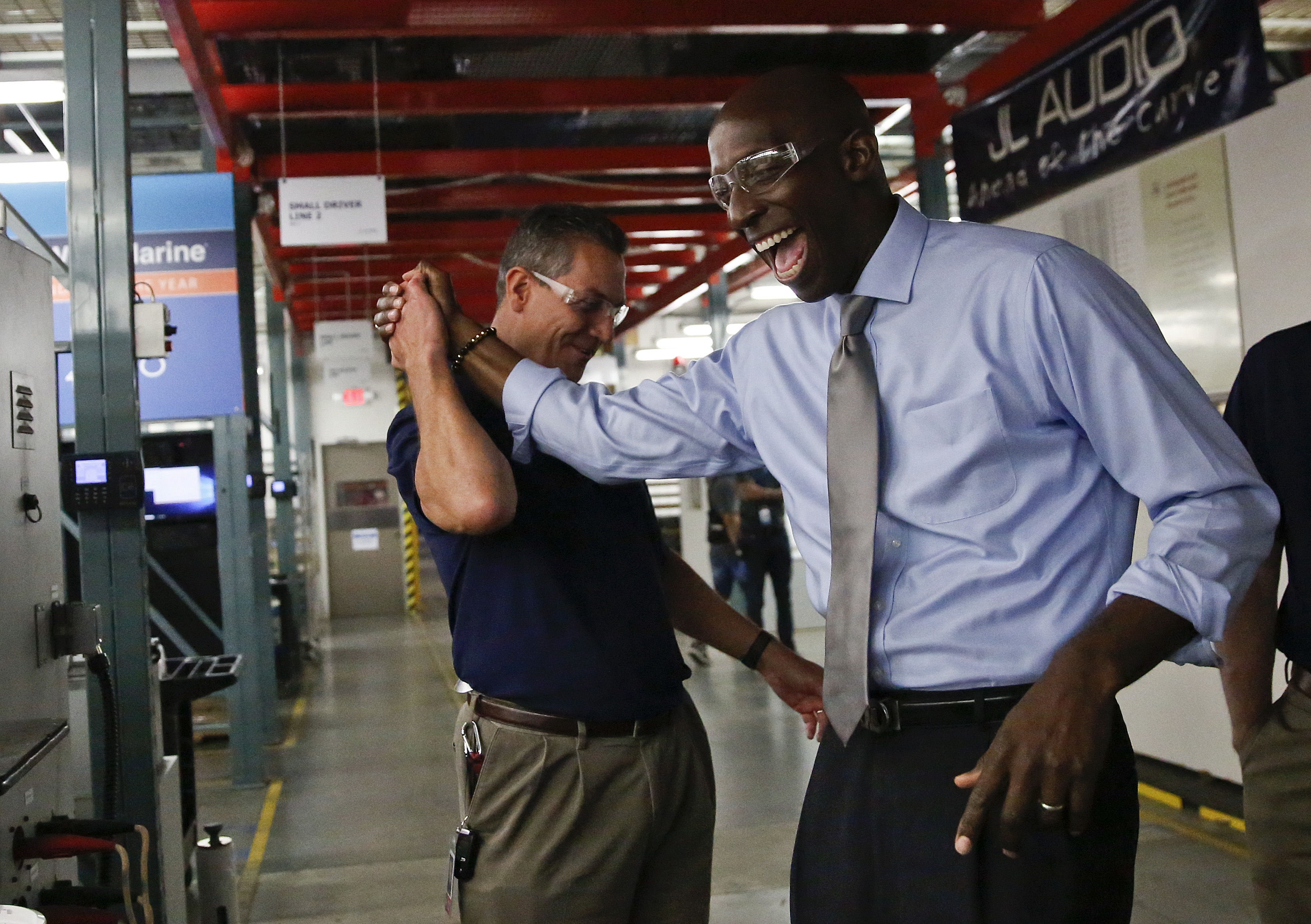 In this Wednesday, March 27, 2019 photo, Miramar Mayor Wayne Messam, right, laughs with Stephen Turrisi, left, the director of training and technical services at JL Audio during a tour in Miramar, Fla. Messam announced on Thursday, March 28 that he is running for the Democratic presidential nomination. (AP Photo/Brynn Anderson) In this Wednesday, March 27, 2019 photo, Miramar Mayor Wayne Messam, right, laughs with Stephen Turrisi, left, the director of training and technical services at JL Audio during a tour in Miramar, Fla. Messam announced on Thursday, March 28 that he is running for the Democratic presidential nomination. (AP Photo/Brynn Anderson)