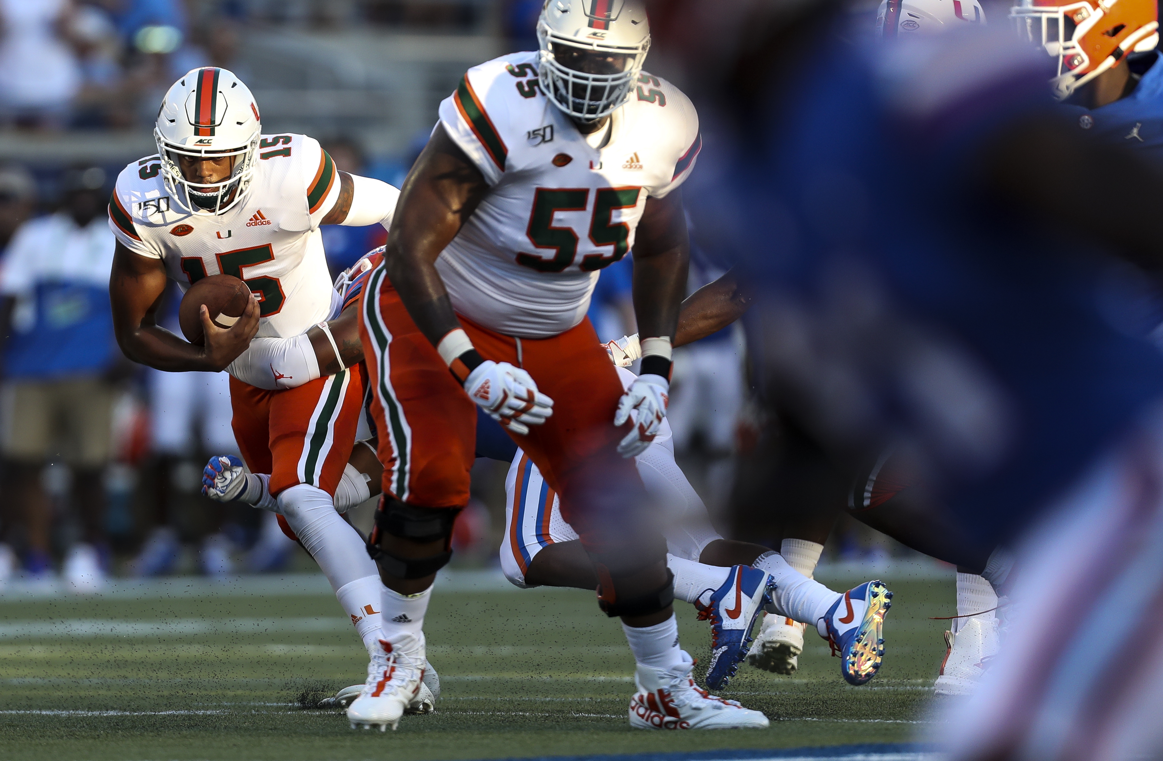 Miami quarterback Jarren Williams tries to elude the grasp of a Florida defender during the season opener in Orlando. MONICA HERNDON | Tampa Bay Times Miami quarterback Jarren Williams tries to elude the grasp of a Florida defender during the season opener in Orlando. MONICA HERNDON | Tampa Bay Times