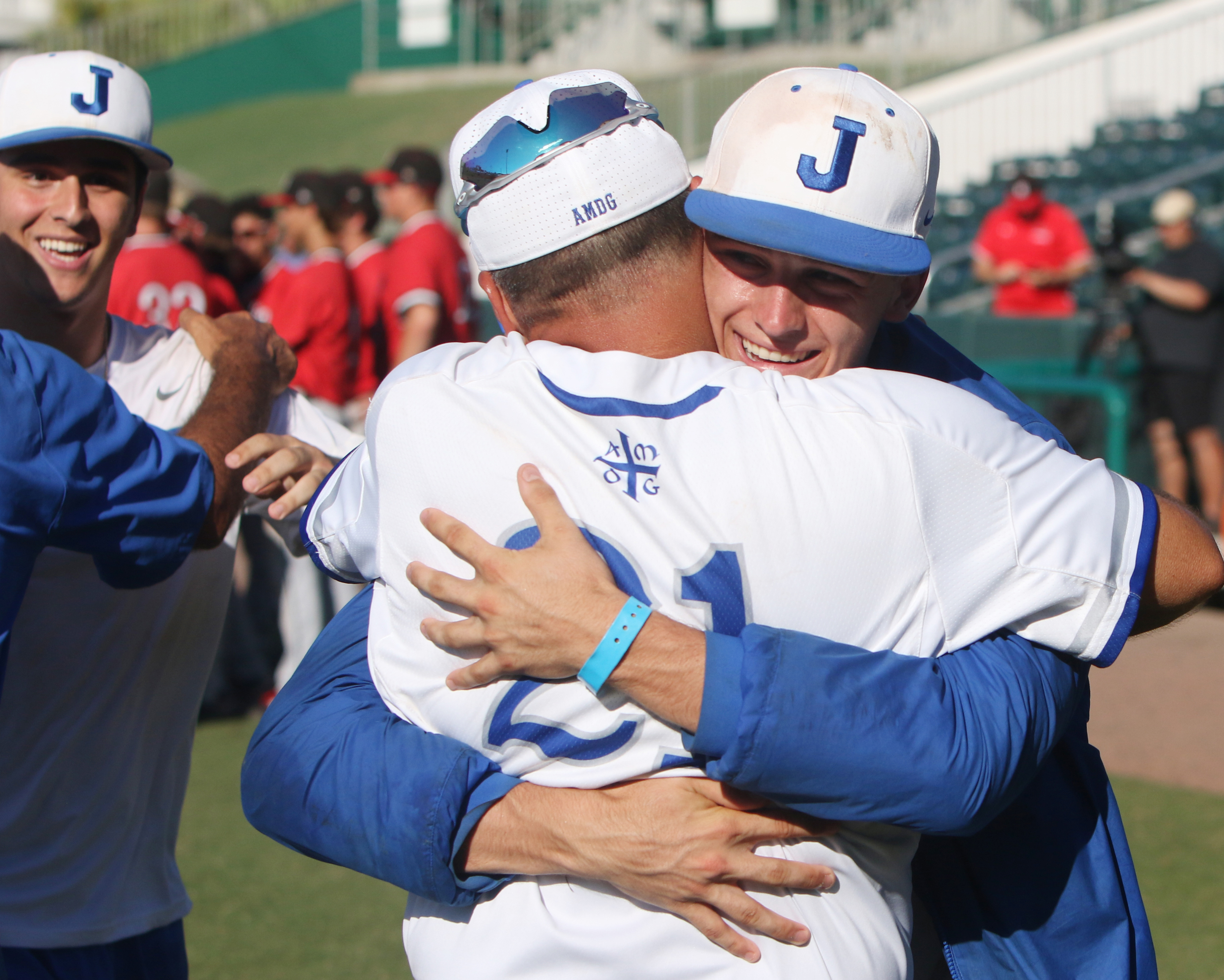 Jesuit ace Camden Minacci gives a huge hug to coach Miguel Menendez moments after the Tigers clinch their fifth state baseball title. (SCOTT PURKS | Special to the Times) Jesuit ace Camden Minacci gives a huge hug to coach Miguel Menendez moments after the Tigers clinch their fifth state baseball title. (SCOTT PURKS | Special to the Times)