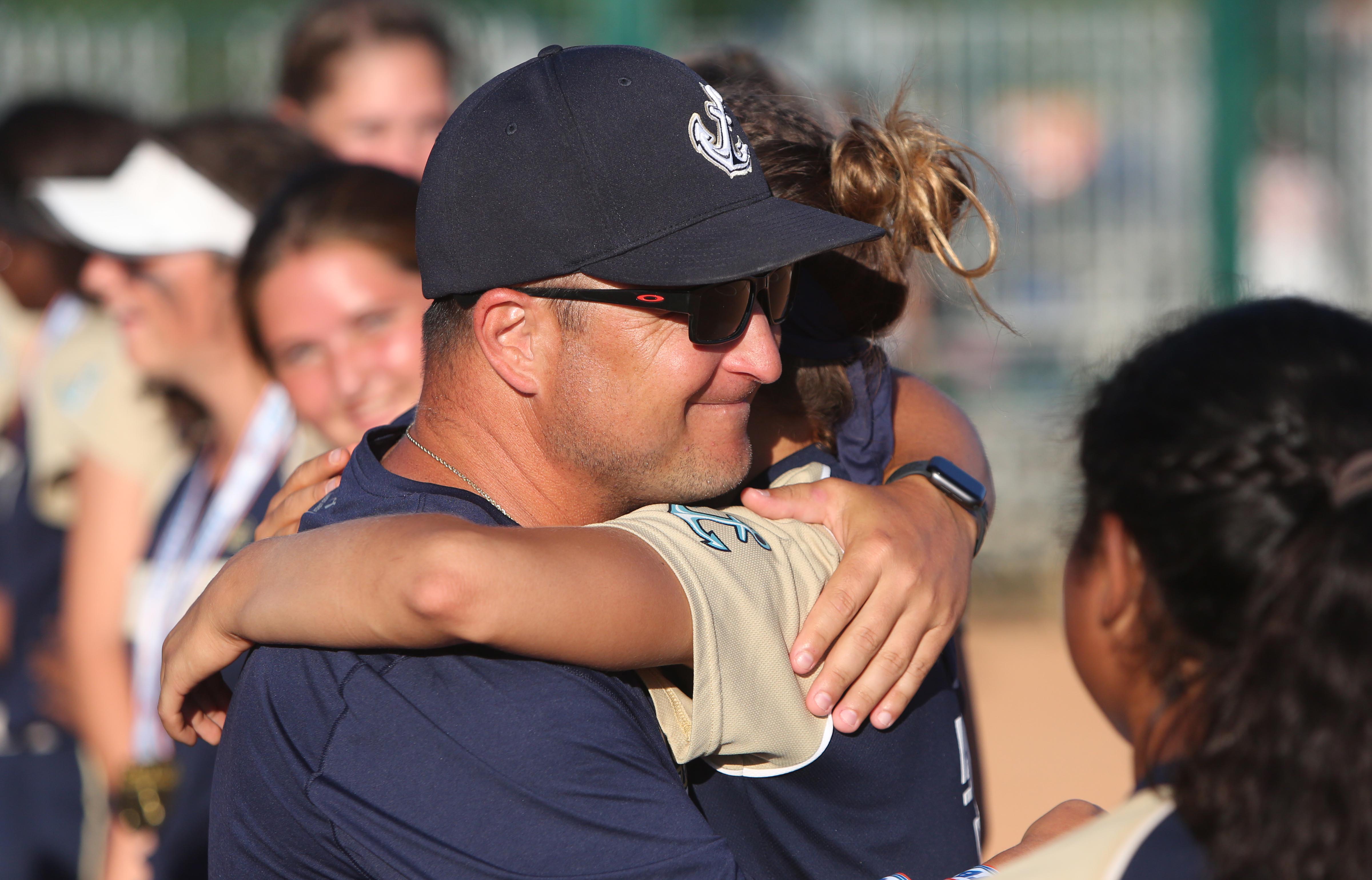 Admiral Farragut coach Bill Hoopes gives a hug to his starting pitcher, Bre Benefield, moments after the Blue Jackets won the Class 3A state titl. (SCOTT PURKS | Special to the Times) Admiral Farragut coach Bill Hoopes gives a hug to his starting pitcher, Bre Benefield, moments after the Blue Jackets won the Class 3A state titl. (SCOTT PURKS | Special to the Times)