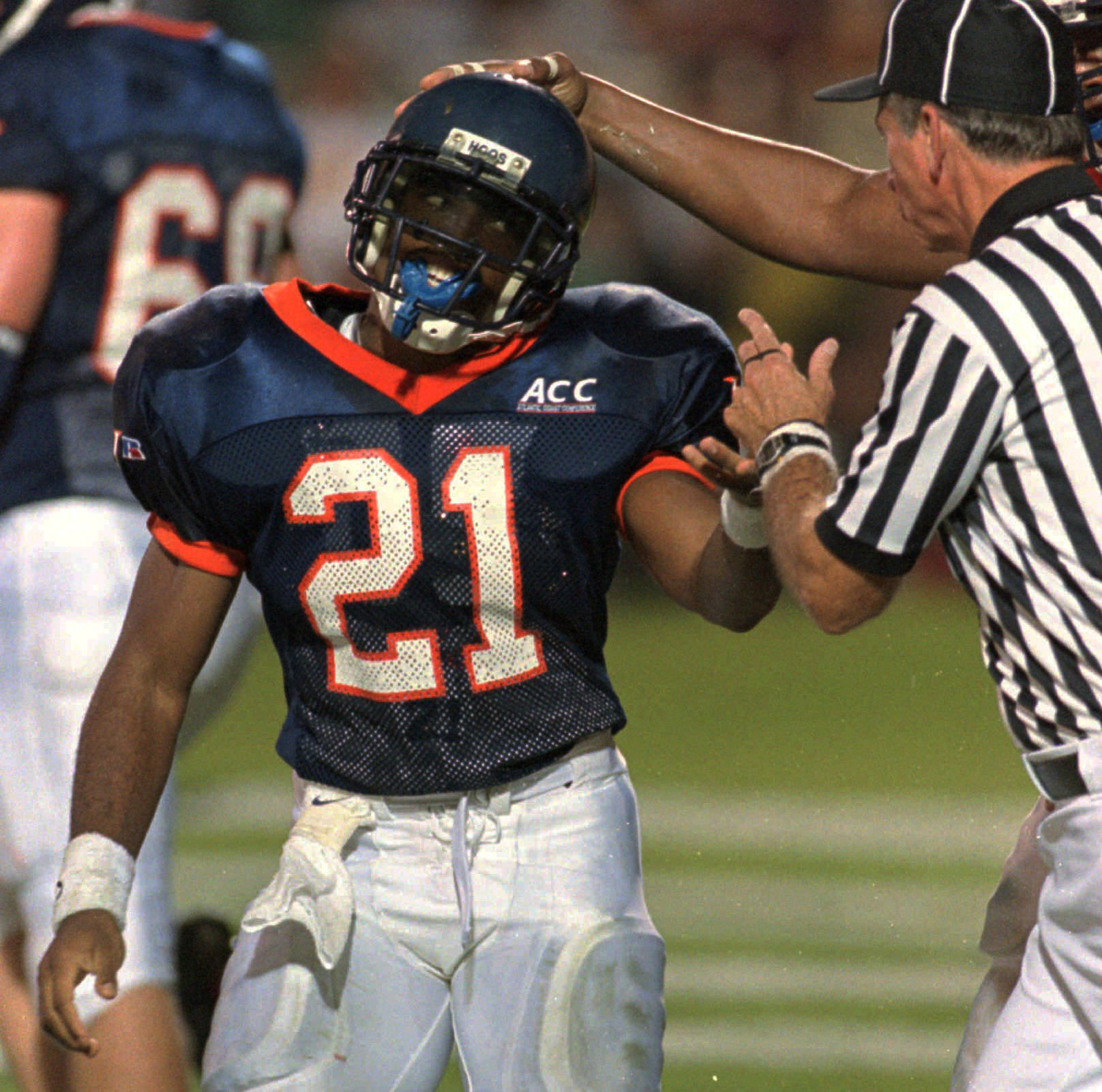 Virginia running back Tiki Barber (21) is congratulated by a teammate as he talks with a referee after scoring the second Cavaliers touchdown during first-half action against Florida State in Charlottesville, Va., on Nov. 2, 1995. (AP Photo/Steve Helber) Virginia running back Tiki Barber (21) is congratulated by a teammate as he talks with a referee after scoring the second Cavaliers touchdown during first-half action against Florida State in Charlottesville, Va., on Nov. 2, 1995. (AP Photo/Steve Helber)