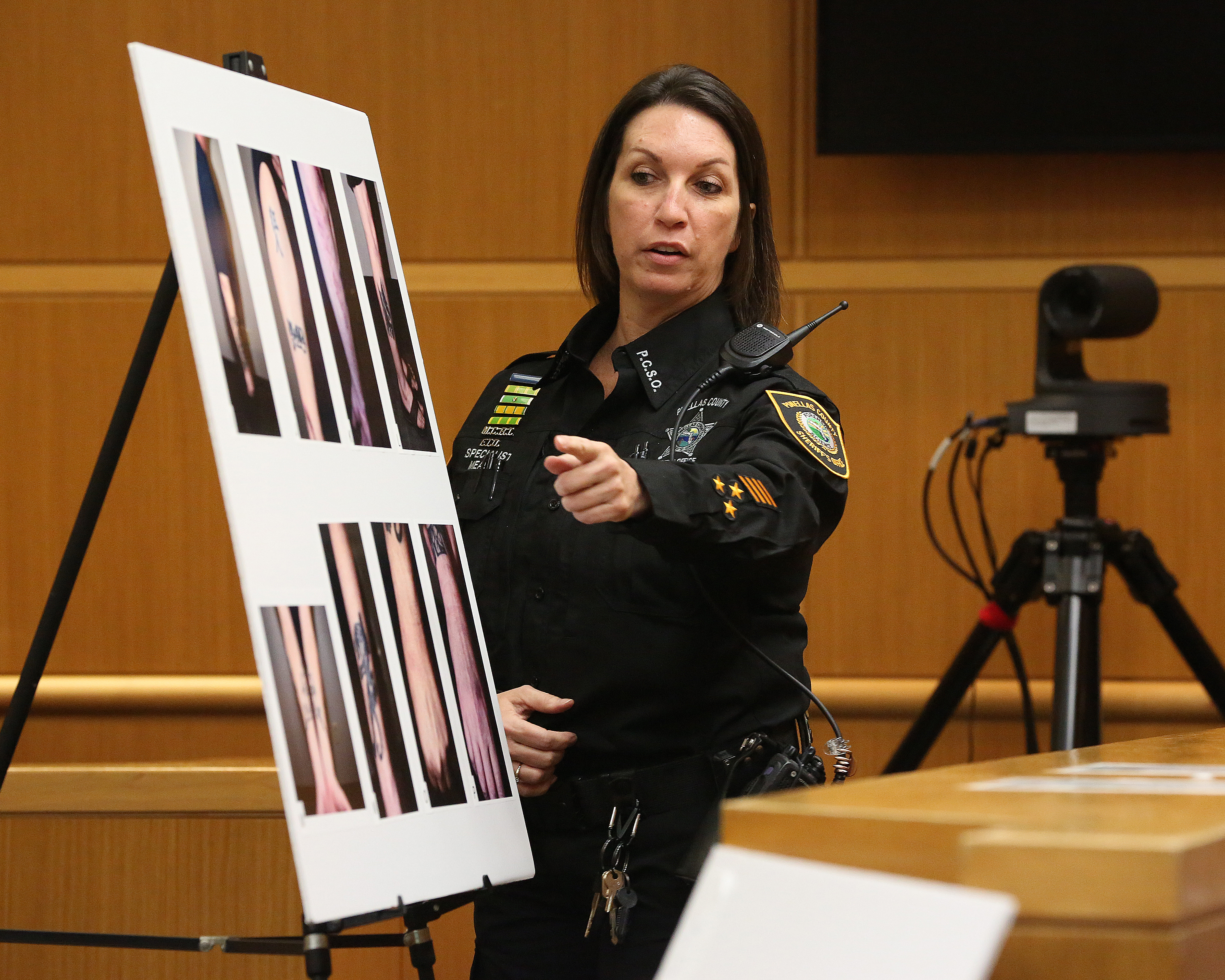 Forensics technician Heather Meade with the Sheriff's Office shows a jury photographs of Michael Drejka's arms and legs. Drejka is standing trial in the shooting death of Markeis McGlockton during an argument over a handicap parking space. SCOTT KEELER | Times Forensics technician Heather Meade with the Sheriff's Office shows a jury photographs of Michael Drejka's arms and legs. Drejka is standing trial in the shooting death of Markeis McGlockton during an argument over a handicap parking space. SCOTT KEELER | Times