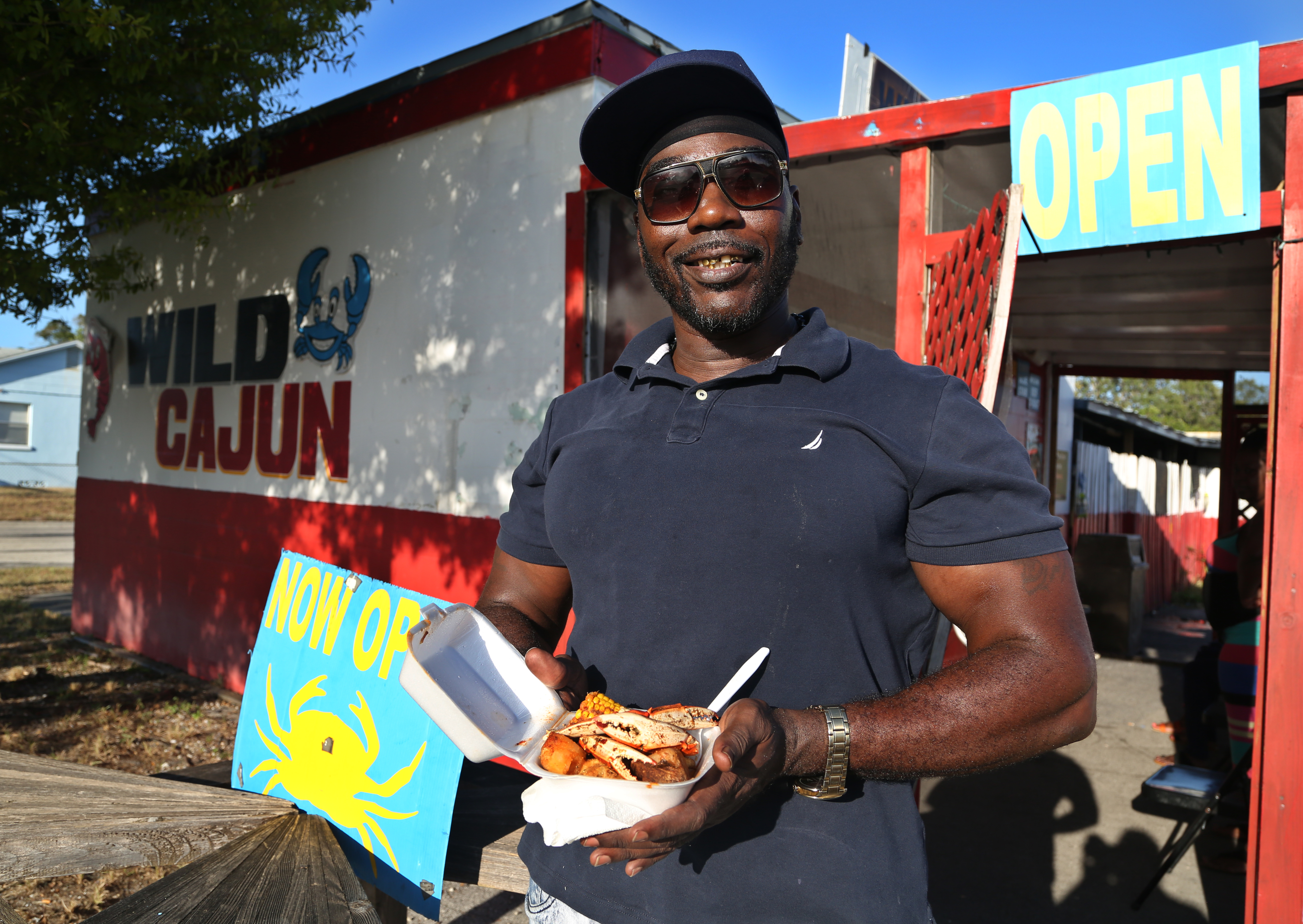 Demetris Lewis, manager/chef at Channels Seafood Market, 640 49th Street South, St. Petersburg, shows off a popular order of steamed, spiced blue crab claws served with corn and potatoes, Friday, October 3, 2019. SCOTT KEELER | Times Demetris Lewis, manager/chef at Channels Seafood Market, 640 49th Street South, St. Petersburg, shows off a popular order of steamed, spiced blue crab claws served with corn and potatoes, Friday, October 3, 2019. SCOTT KEELER | Times