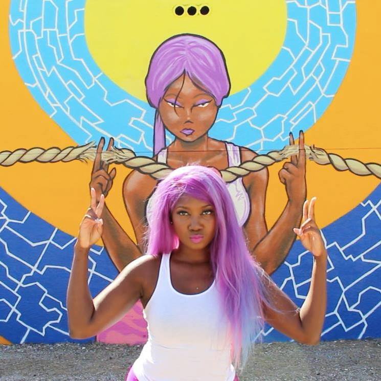 Niajae Wallace walked by the Ink Werkz Crew working on their mural one night in 2015 and noticed the uncanny similarity. Wallace keeps her hair dyed purple. Niajae Wallace Niajae Wallace walked by the Ink Werkz Crew working on their mural one night in 2015 and noticed the uncanny similarity. Wallace keeps her hair dyed purple. Niajae Wallace