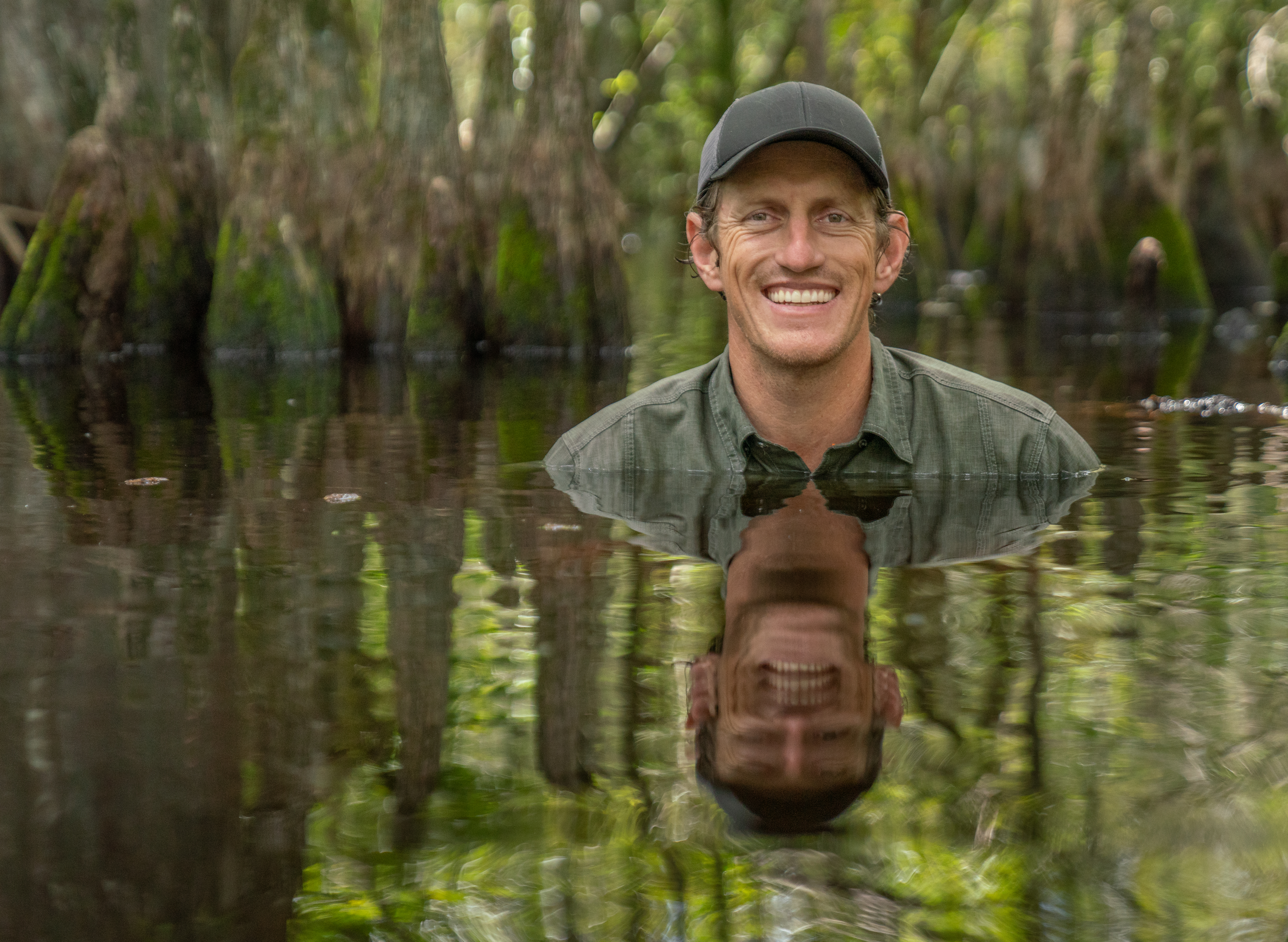 Carlton Ward Jr. cools off in the swamp after servicing a camera trap at Florida Panther National Wildlife Refuge. Veronica Runge | by Veronica Runge Carlton Ward Jr. cools off in the swamp after servicing a camera trap at Florida Panther National Wildlife Refuge. Veronica Runge | by Veronica Runge
