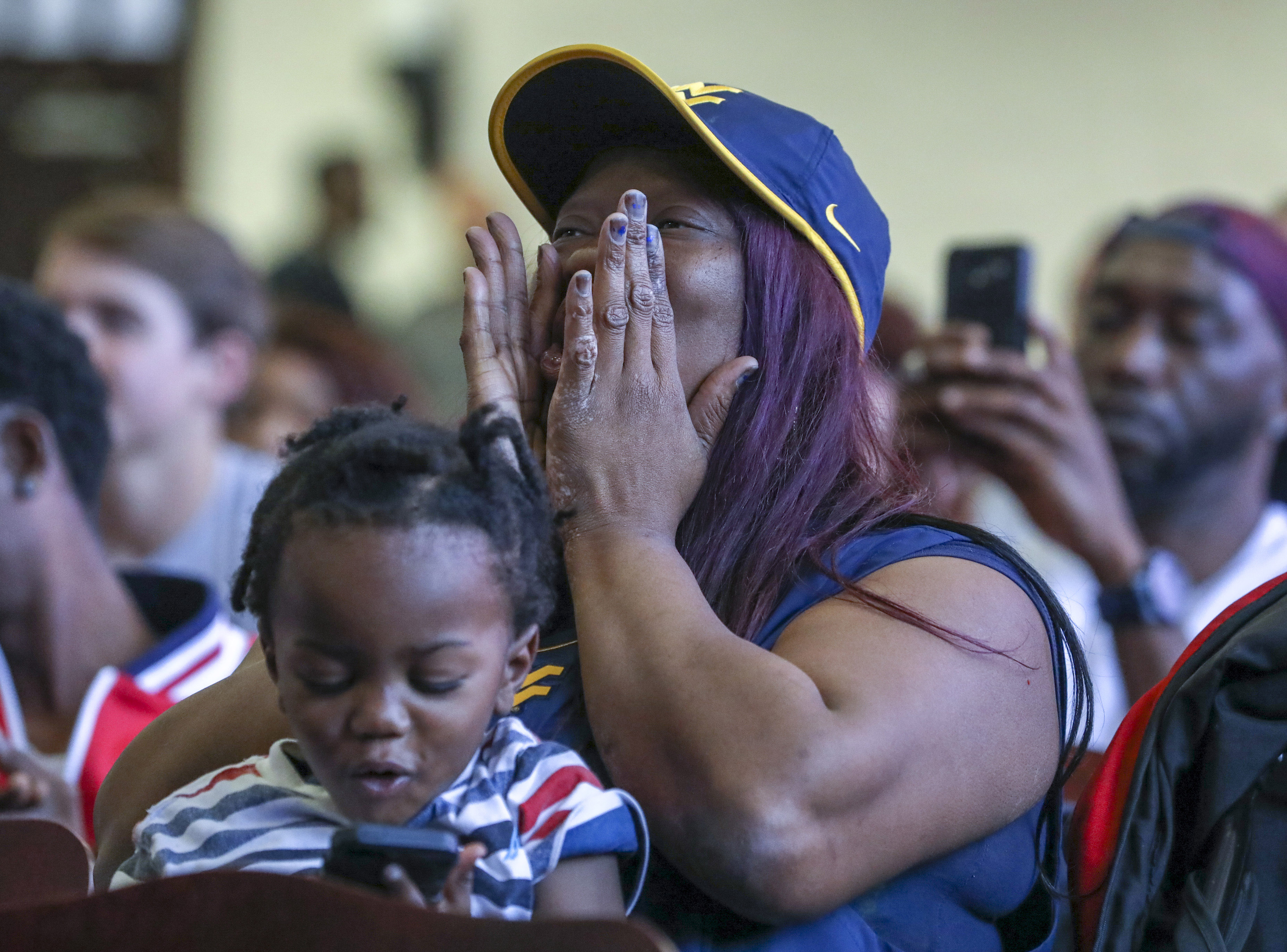 Stephanie Harmon, Terence Doston's mother, cheers from her seat while holding Dotson's little brother, Jamie, 1. (CHRIS URSO | Times) Stephanie Harmon, Terence Doston's mother, cheers from her seat while holding Dotson's little brother, Jamie, 1. (CHRIS URSO | Times)