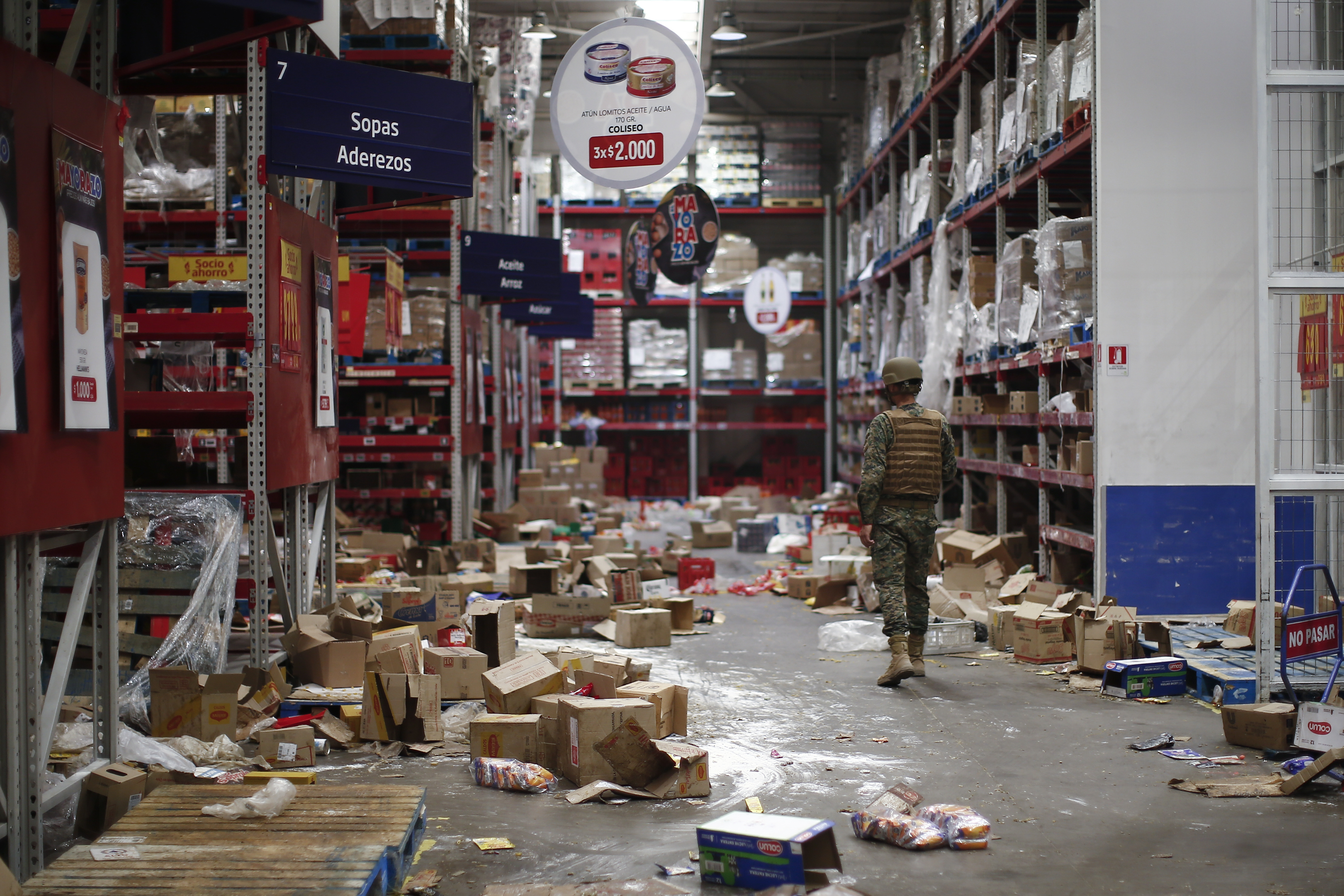 A soldier walks inside a looted supermarket in Santiago, Chile, Tuesday, Oct. 22, 2019. Chile has been facing days of unrest, triggered by a relatively minor increase in subway fares. The protests have shaken a nation noted for economic stability over the past decades, which has seen steadily declining poverty despite persistent high rates of inequality. Luis Hidalgo | AP A soldier walks inside a looted supermarket in Santiago, Chile, Tuesday, Oct. 22, 2019. Chile has been facing days of unrest, triggered by a relatively minor increase in subway fares. The protests have shaken a nation noted for economic stability over the past decades, which has seen steadily declining poverty despite persistent high rates of inequality. Luis Hidalgo | AP