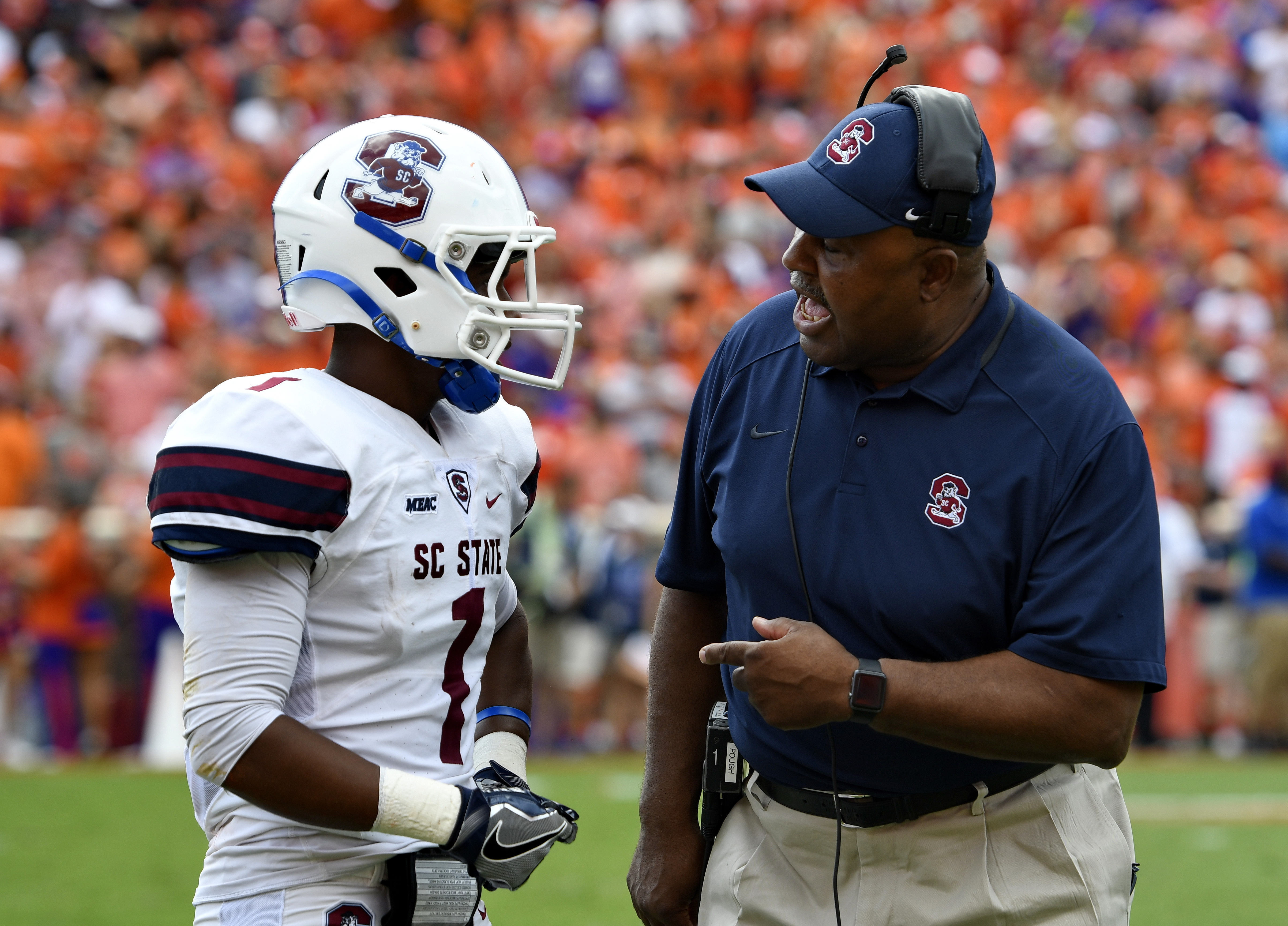 South Carolina State coach Buddy Pough speaks with Ahmaad Harris after Harris fumbled in the end zone against Clemson in a 2016 game. Richard Shiro | AP South Carolina State coach Buddy Pough speaks with Ahmaad Harris after Harris fumbled in the end zone against Clemson in a 2016 game. Richard Shiro | AP