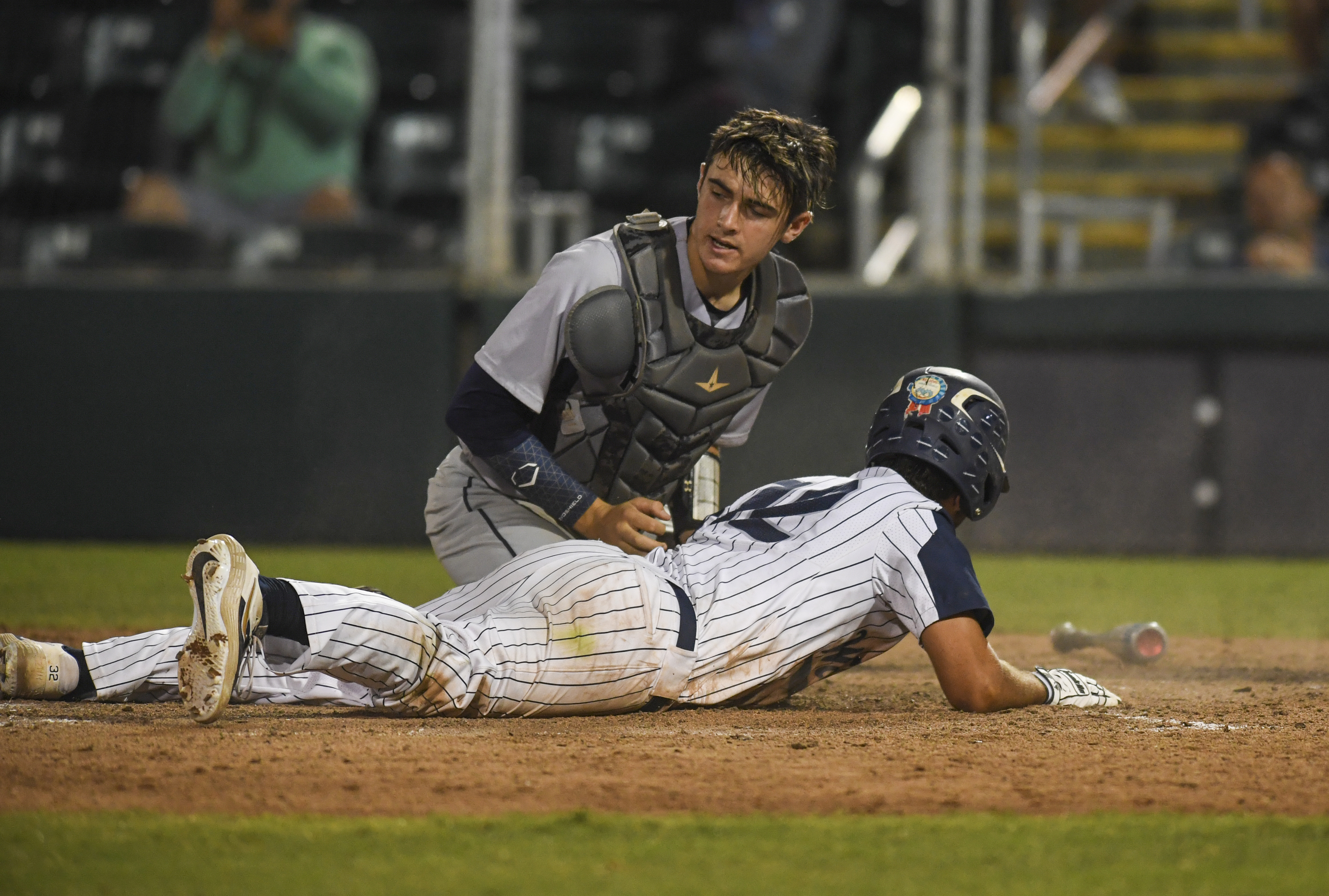 Calvary Christian's Peter Stavrakos (12) slides safely into home, scoring the winning run in the bottom of the seventh inning. (ALLIE GOULDING | Times) Calvary Christian's Peter Stavrakos (12) slides safely into home, scoring the winning run in the bottom of the seventh inning. (ALLIE GOULDING | Times)