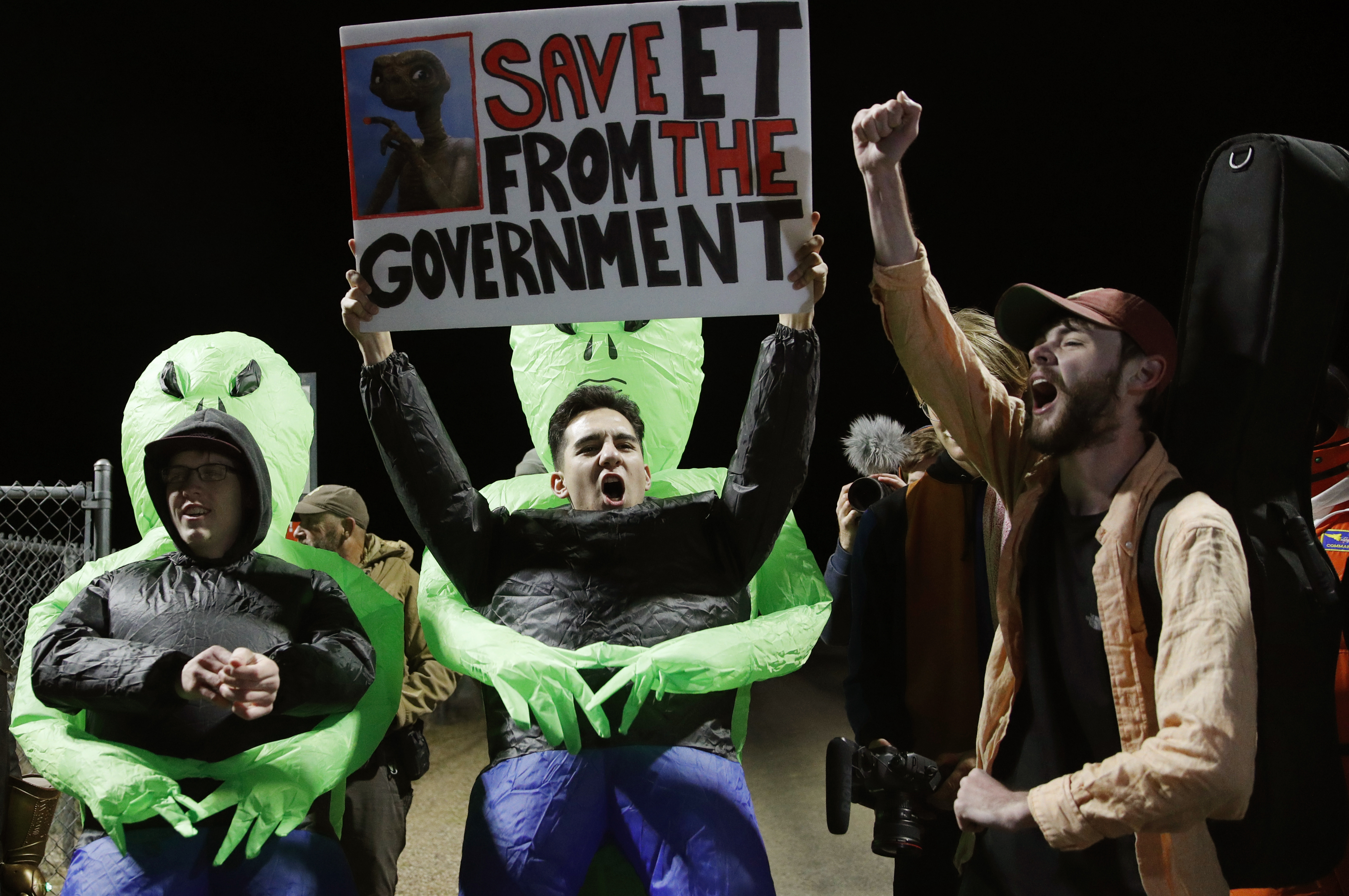 Mario Rayna, center, chants with others at an entrance to the Nevada Test and Training Range near Area 51 Friday, Sept. 20, 2019, near Rachel, Nev. People gathered at the gate inspired by the Mario Rayna, center, chants with others at an entrance to the Nevada Test and Training Range near Area 51 Friday, Sept. 20, 2019, near Rachel, Nev. People gathered at the gate inspired by the