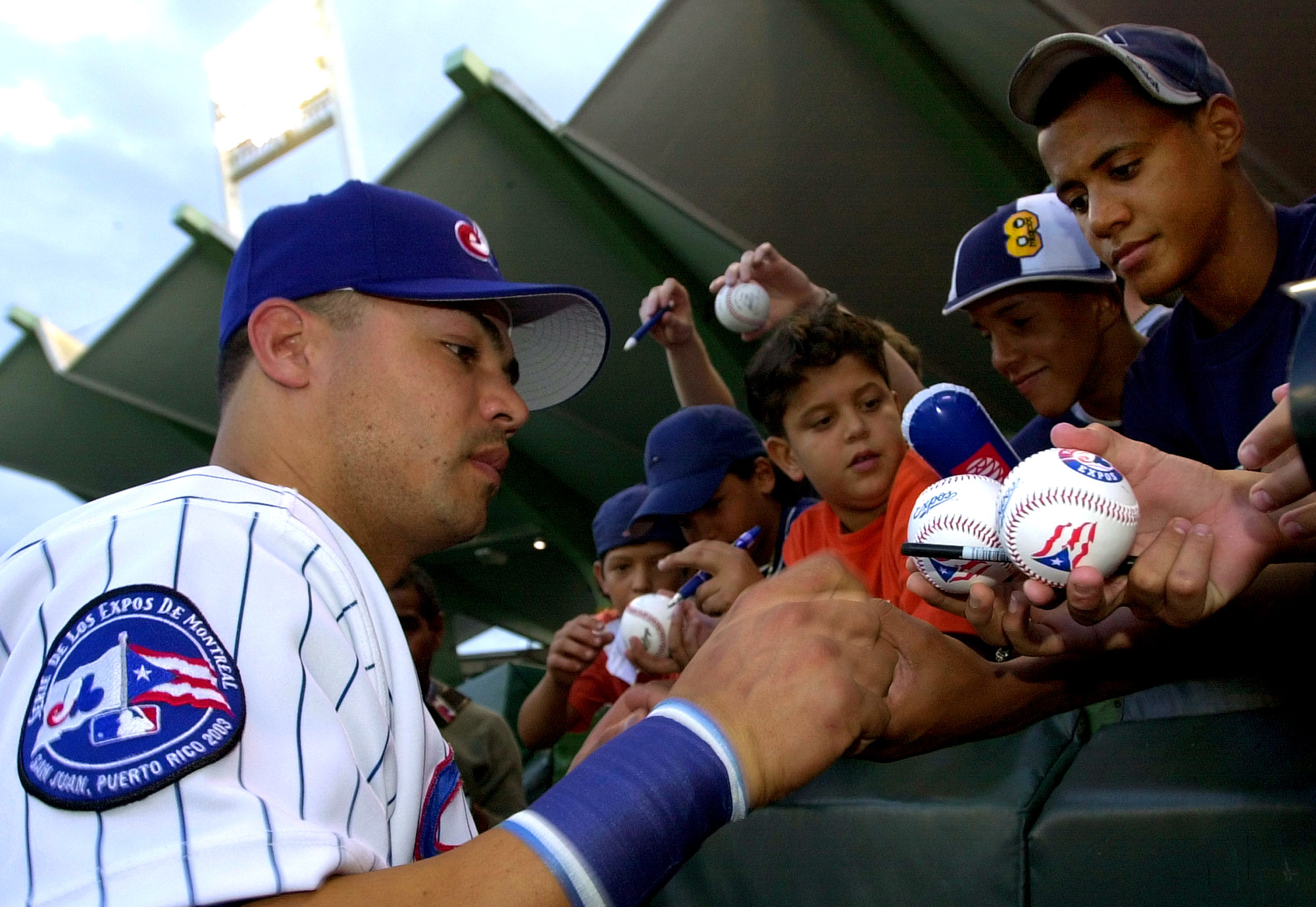 In this file photo, Jose Vidro of the Montreal Expos signs autographs for fans prior to the Expos' June 2, 2003, game against the Angels at Hiram Bithorn Stadium. The Expos split parts of two seasons between Montreal and San Juan before moving to Washington. (AP Photo/Lynne Sladky) In this file photo, Jose Vidro of the Montreal Expos signs autographs for fans prior to the Expos' June 2, 2003, game against the Angels at Hiram Bithorn Stadium. The Expos split parts of two seasons between Montreal and San Juan before moving to Washington. (AP Photo/Lynne Sladky)