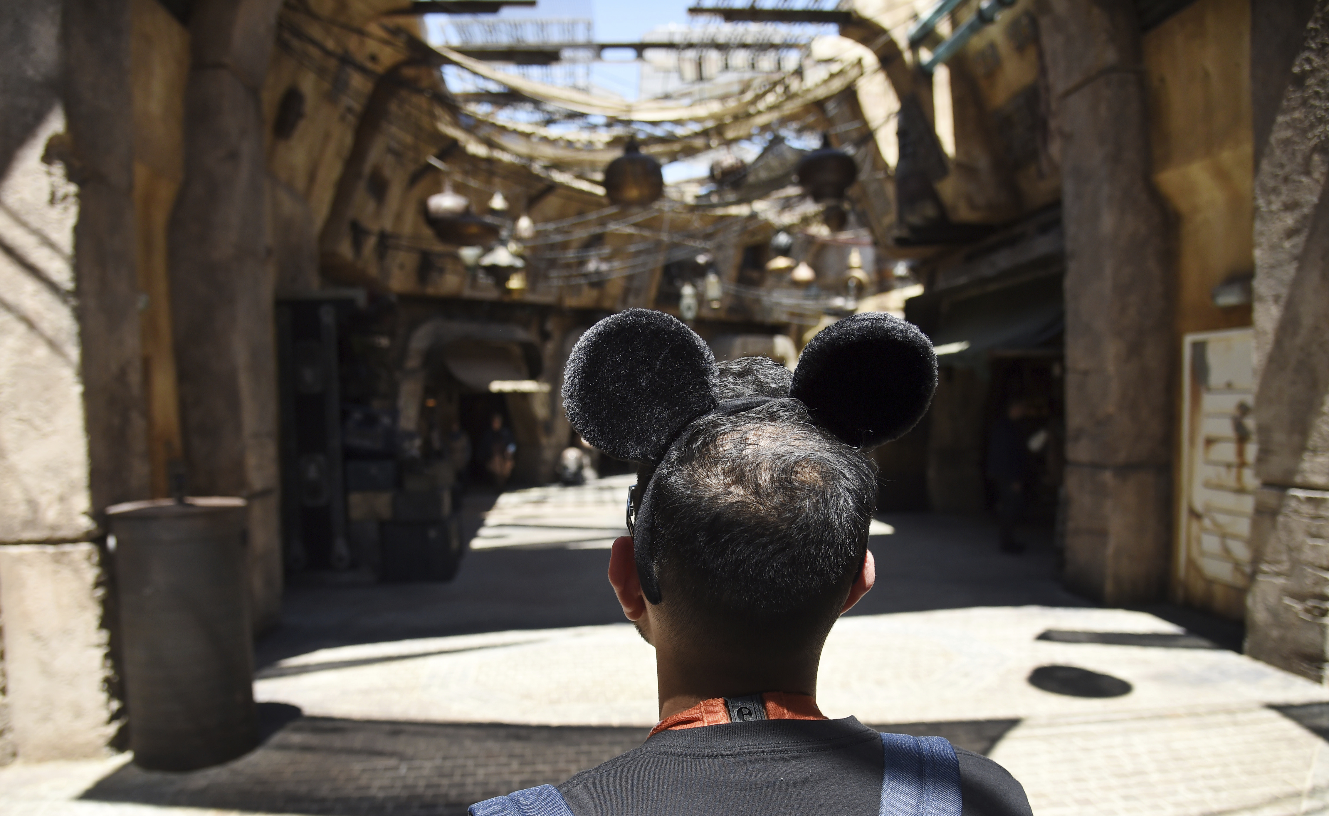 A visitor peers down the marketplace of the Black Spire Outpost at Star Wars: Galaxy's Edge at Disneyland Park in Anaheim, Calif. Chris Pizzello | Chris Pizzello/Invision/AP A visitor peers down the marketplace of the Black Spire Outpost at Star Wars: Galaxy's Edge at Disneyland Park in Anaheim, Calif. Chris Pizzello | Chris Pizzello/Invision/AP