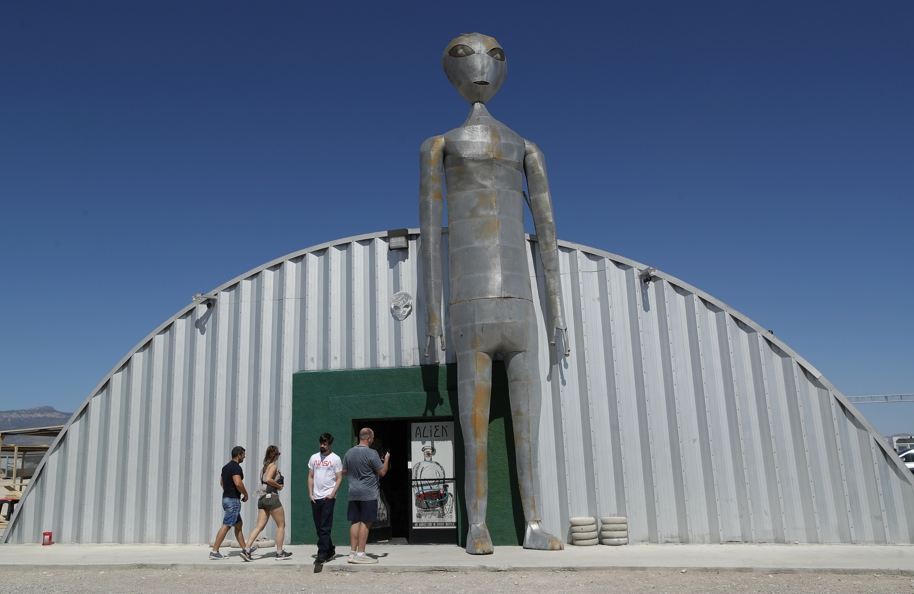 People enter and exit the Alien Research Center in Hiko, Nev. No one knows what to expect, but lots of people are preparing for People enter and exit the Alien Research Center in Hiko, Nev. No one knows what to expect, but lots of people are preparing for