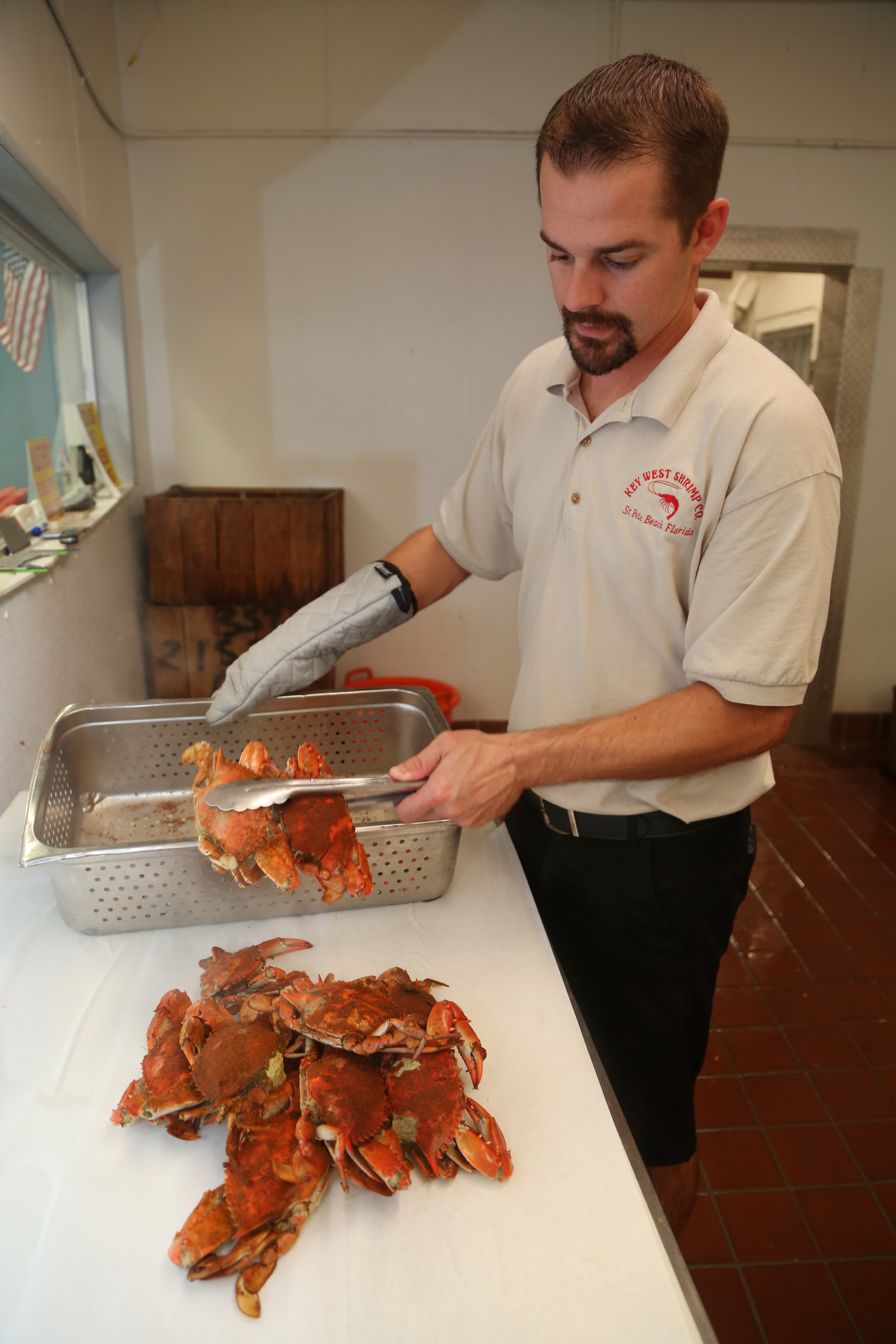 CJ Hnilica, manager of Key West Seafood Company, Gulfport, shows off some steamed blue crabs that were displayed in the seafood case at the business, Wednesday, October 2, 2019. The crabs were steamed and seasoned for 10 minutes. SCOTT KEELER | Times CJ Hnilica, manager of Key West Seafood Company, Gulfport, shows off some steamed blue crabs that were displayed in the seafood case at the business, Wednesday, October 2, 2019. The crabs were steamed and seasoned for 10 minutes. SCOTT KEELER | Times