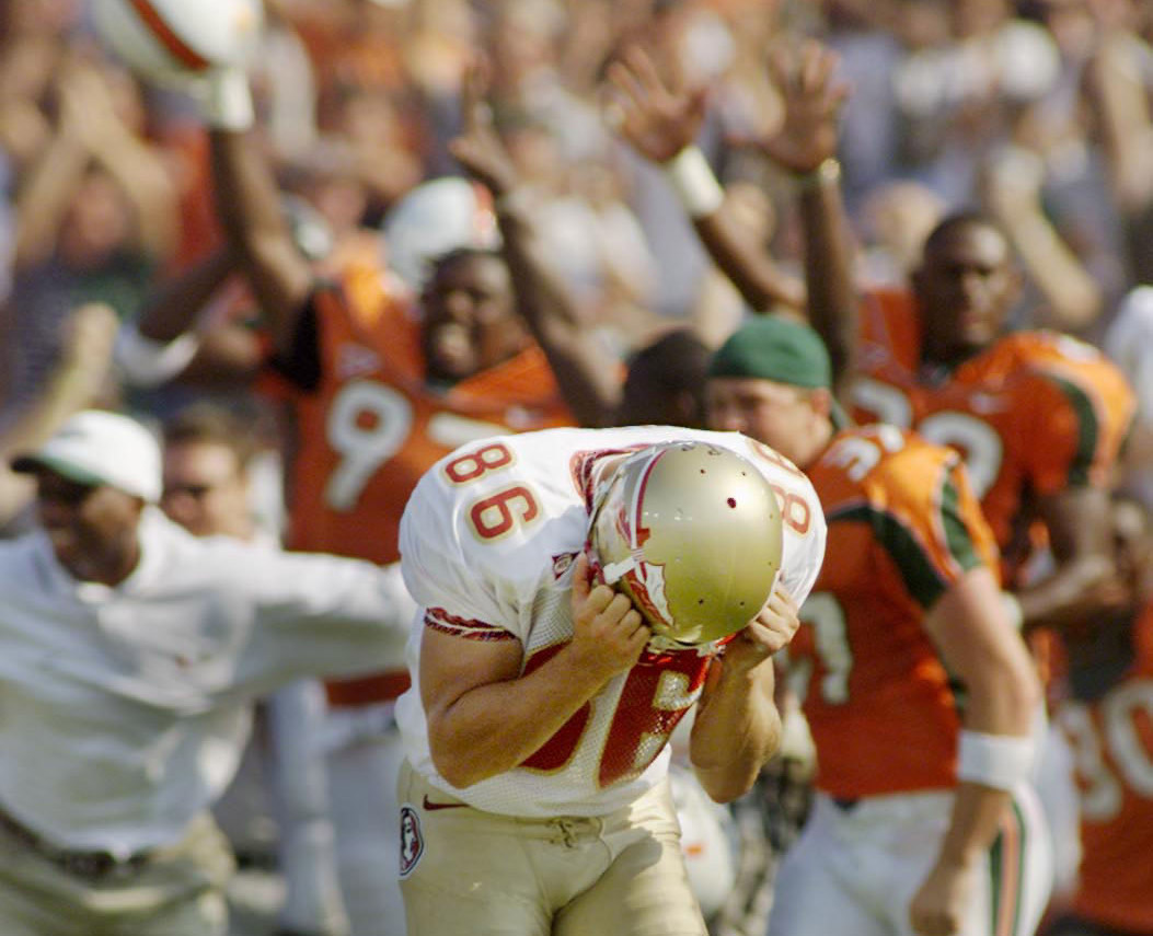 FSU kicker Matt Munyon reacts after his attempt to tie the score with a field goal failed as the Miami bench erupts in celebration. FSU lost to Miami 27-24. (Times, 2000) FSU kicker Matt Munyon reacts after his attempt to tie the score with a field goal failed as the Miami bench erupts in celebration. FSU lost to Miami 27-24. (Times, 2000)