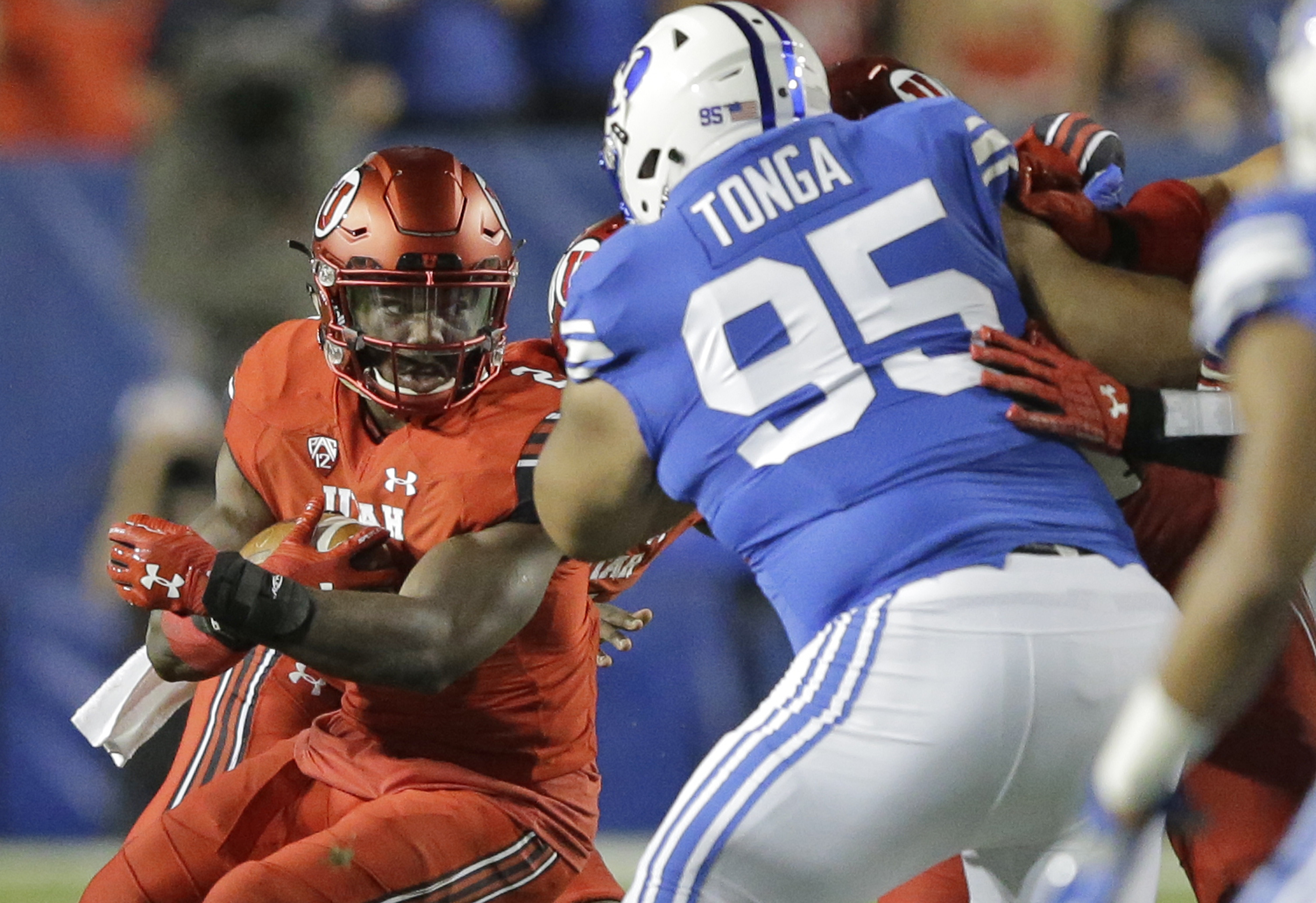 Utah running back Zack Moss (2) carries the ball as BYU defensive lineman Khyiris Tonga (95) defends in the first half of the Utes' victory last month in Provo, Utah.(AP Photo/Rick Bowmer) Rick Bowmer | AP Utah running back Zack Moss (2) carries the ball as BYU defensive lineman Khyiris Tonga (95) defends in the first half of the Utes' victory last month in Provo, Utah.(AP Photo/Rick Bowmer) Rick Bowmer | AP