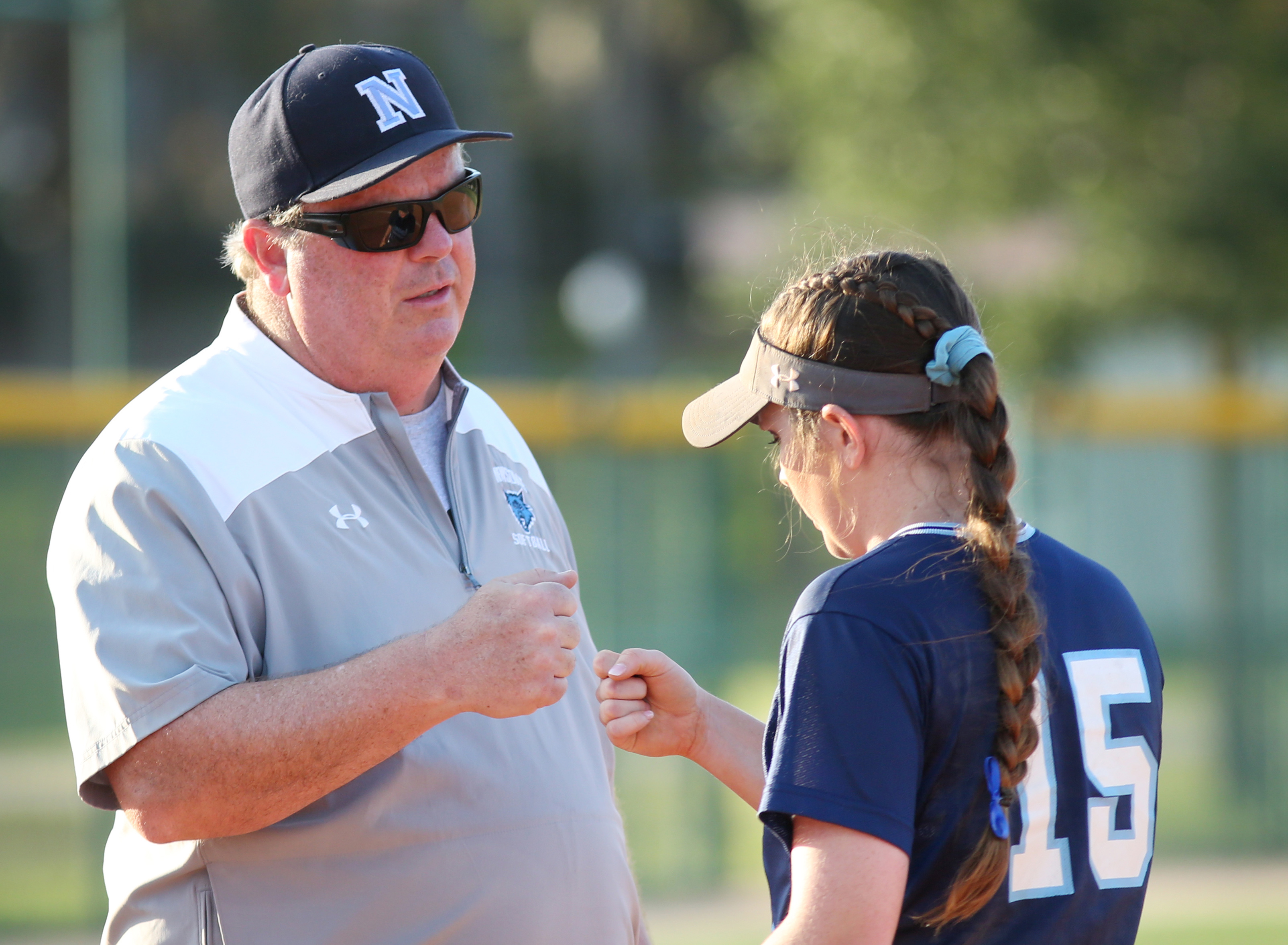 Newsome assistant coach Greg Feldman gives his daughter, starting pitcher Mary Beth Feldman, a few words of encouragement moments before the Class 9A state final. (SCOTT PURKS | Special to the Times)_ Newsome assistant coach Greg Feldman gives his daughter, starting pitcher Mary Beth Feldman, a few words of encouragement moments before the Class 9A state final. (SCOTT PURKS | Special to the Times)_