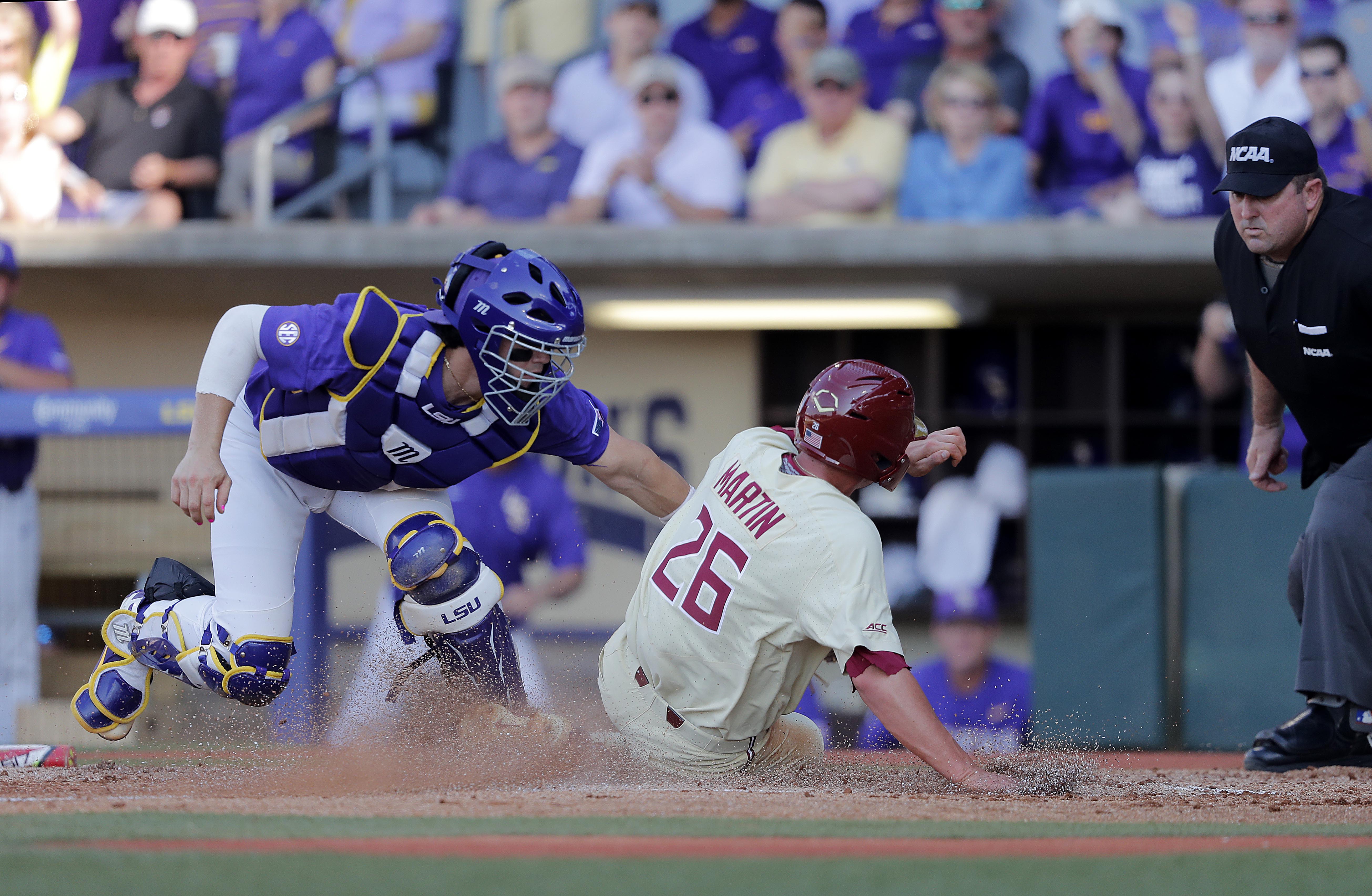Florida State's Robby Martin (26) scores on a fielding error by LSU catcher Saul Garza, left, in the second inning of Game 2 of the NCAA college baseball super regional tournament in Baton Rouge, La., June 9, 2019. (AP Photo/Gerald Herbert) Florida State's Robby Martin (26) scores on a fielding error by LSU catcher Saul Garza, left, in the second inning of Game 2 of the NCAA college baseball super regional tournament in Baton Rouge, La., June 9, 2019. (AP Photo/Gerald Herbert)