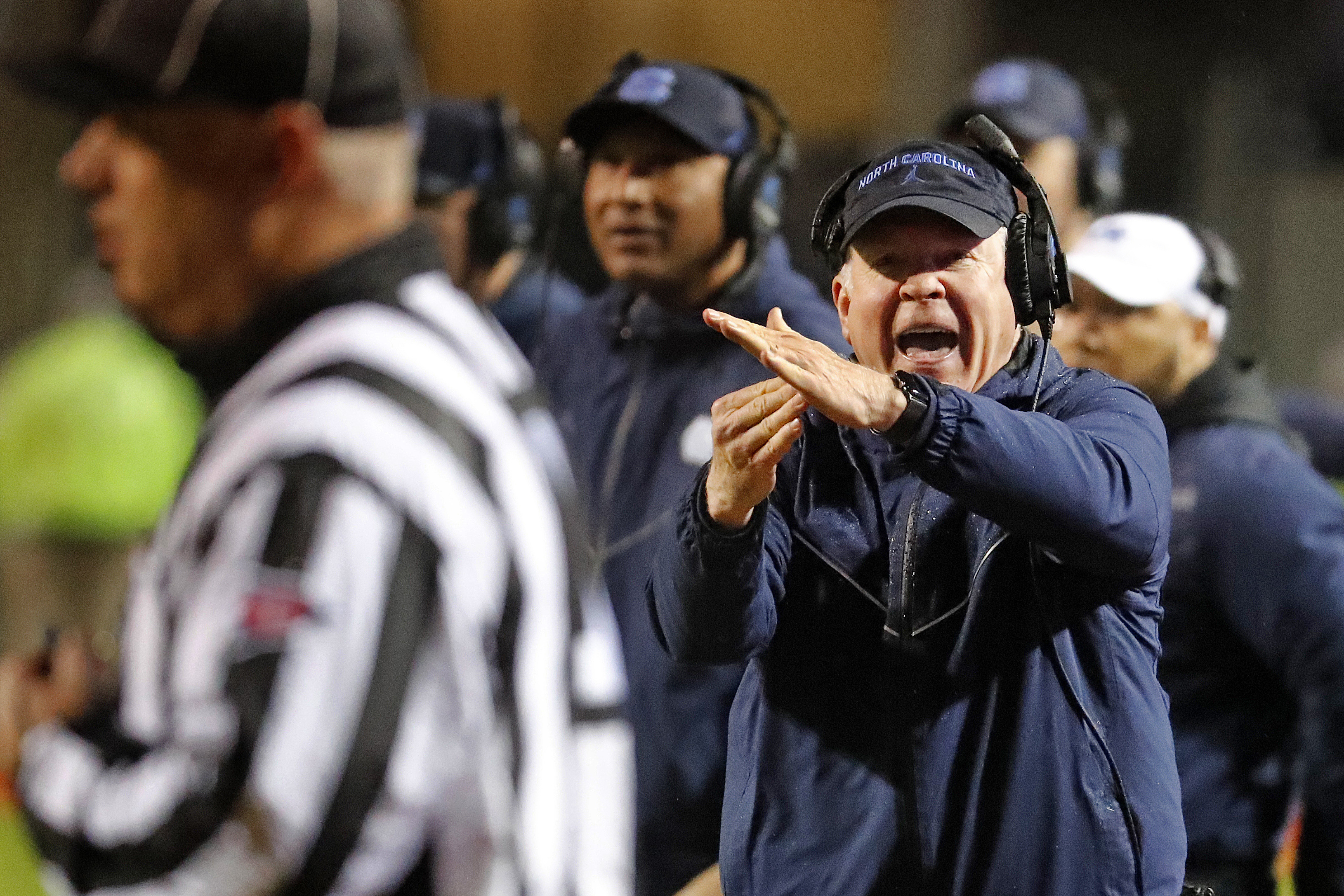 North Carolina head coach Mack Brown runs to take a timeout during the first half against North Carolina State in Raleigh, N.C. on Nov. 30. Karl B DeBlaker | AP North Carolina head coach Mack Brown runs to take a timeout during the first half against North Carolina State in Raleigh, N.C. on Nov. 30. Karl B DeBlaker | AP