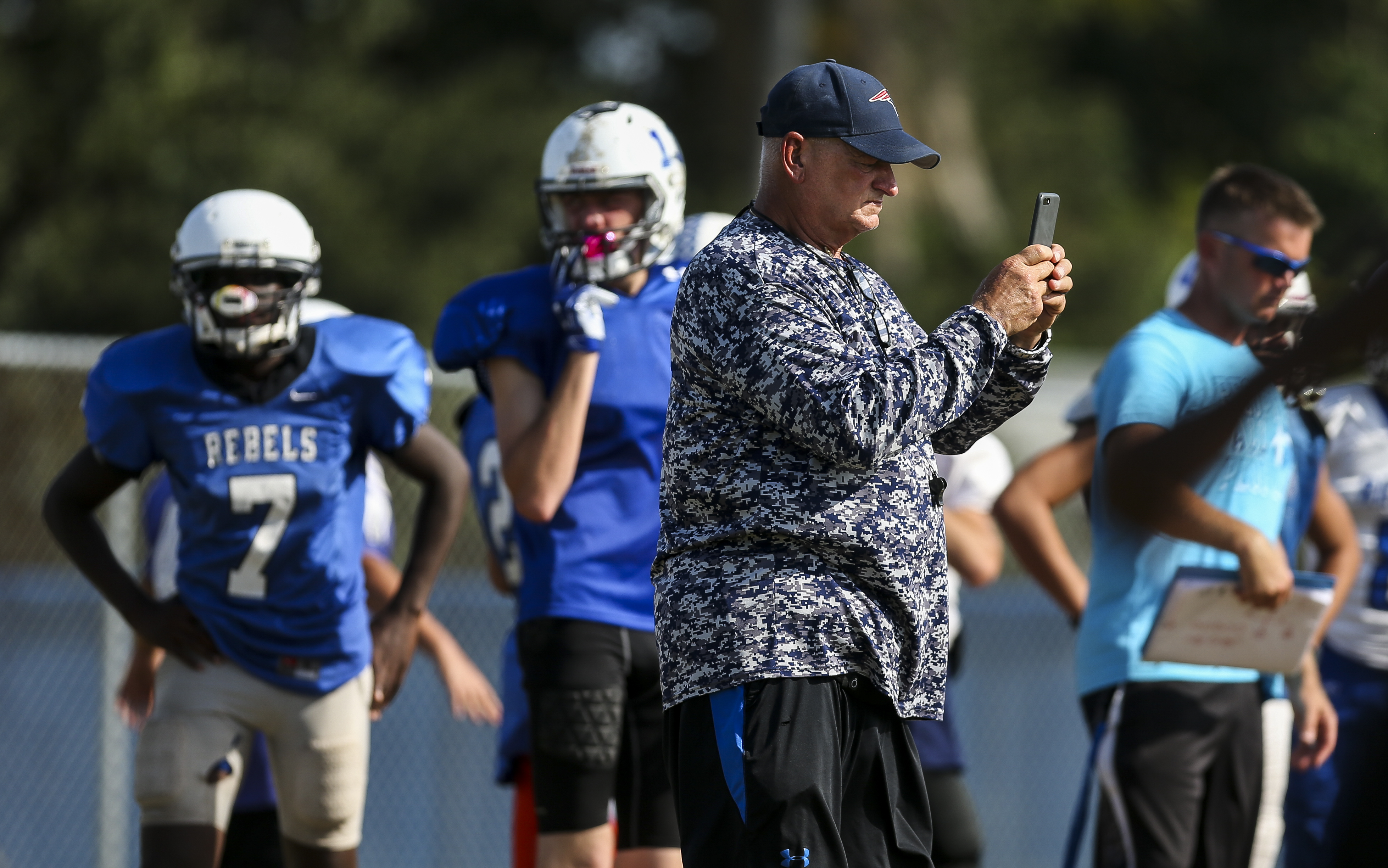 Coach Dale Caparaso records during football practice at Dixie Hollins. He'll be facing his old team, Pasco, on Friday. MONICA HERNDON | Times Coach Dale Caparaso records during football practice at Dixie Hollins. He'll be facing his old team, Pasco, on Friday. MONICA HERNDON | Times